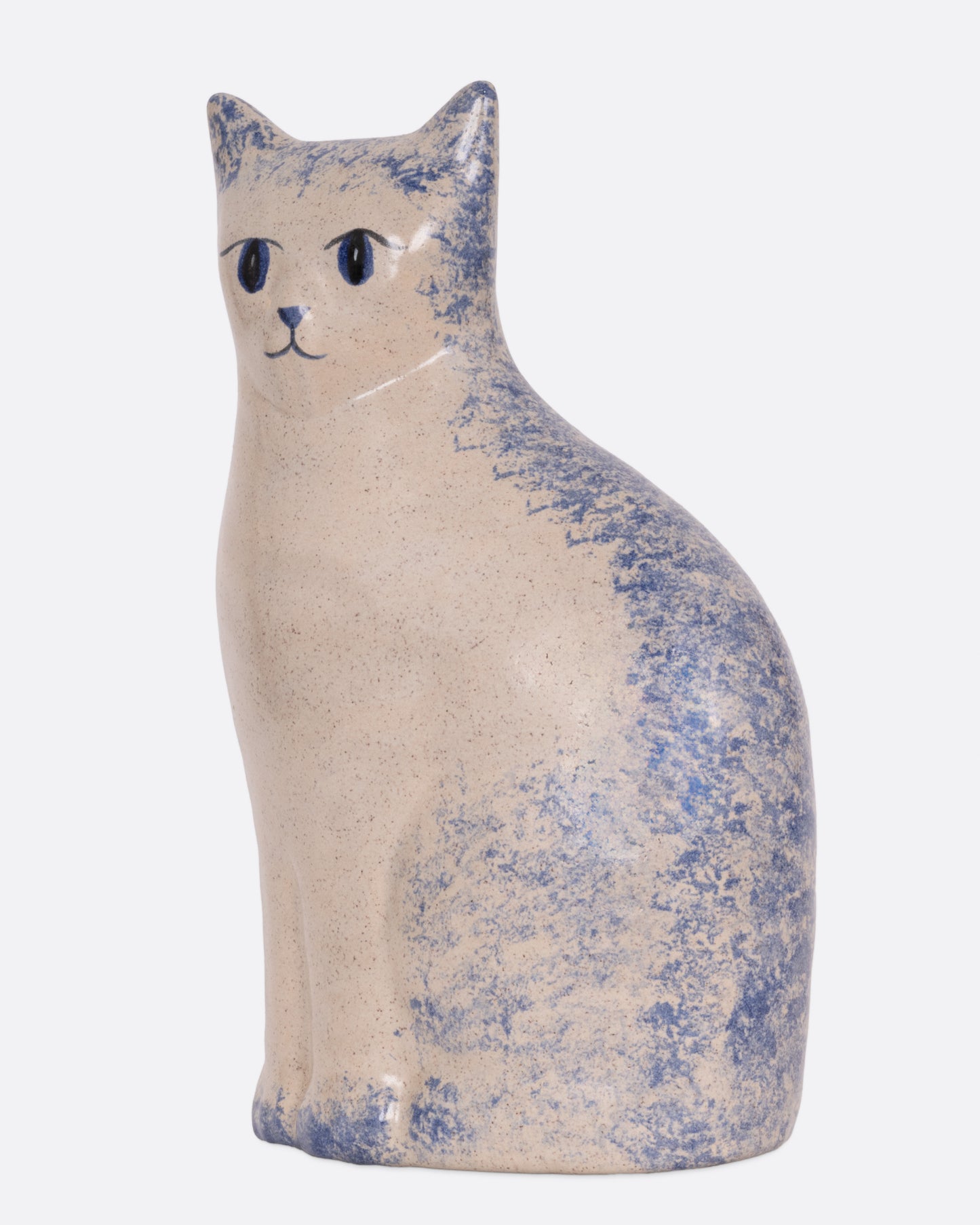 A ceramic cat figurine with blue speckles, shown from the side.