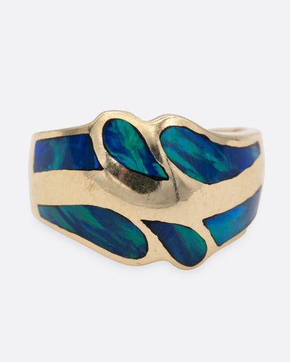 A yellow gold ring with an abstract inlay of opal. Shown from the front.