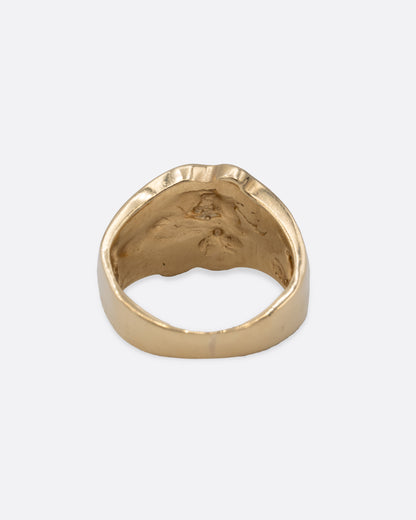 A yellow gold ring with an abstract inlay of opal. Shown from the back.