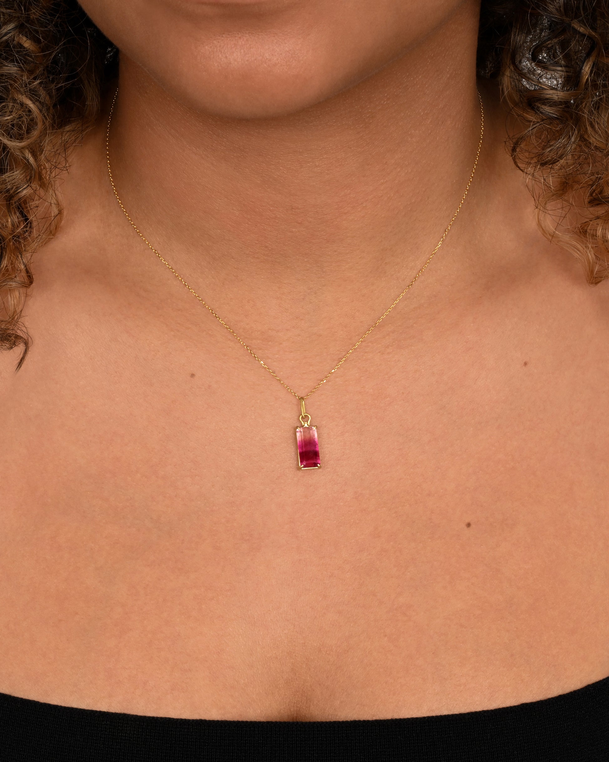 prong set pink tourmaline pendant shown from the side. worn around the neck