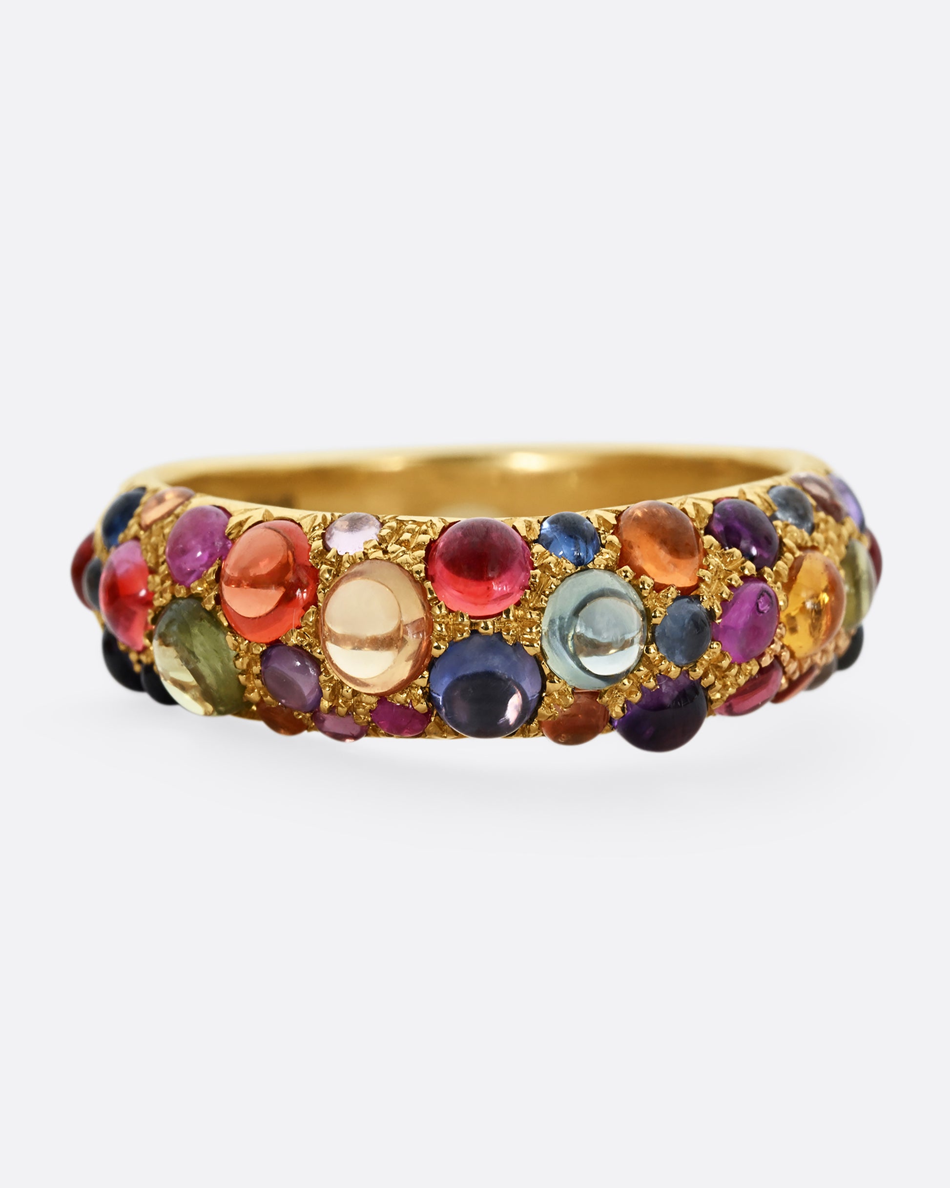 Multicolor sapphire cabochons set in an 18k yellow gold band. Shown from the front.