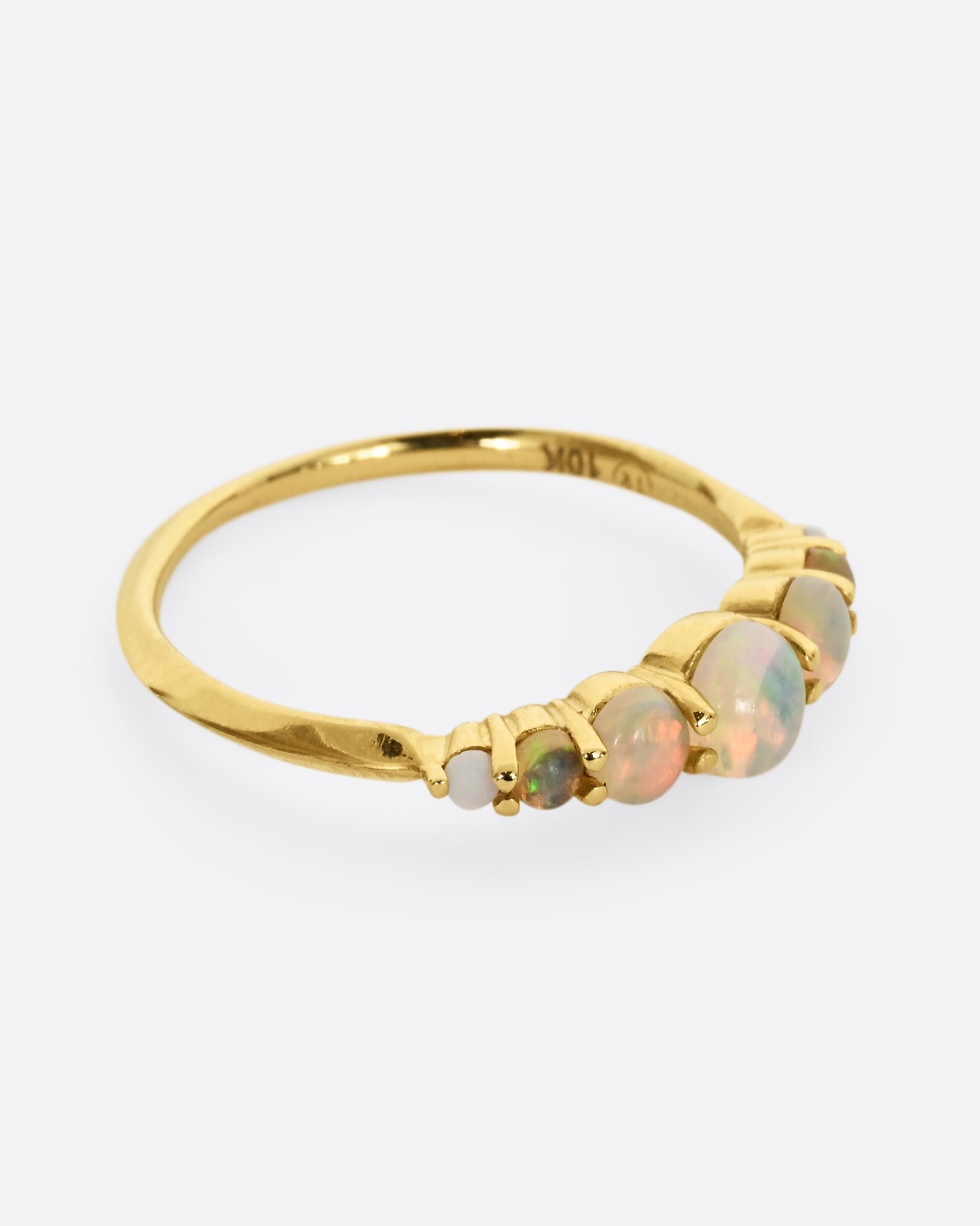 Seven graduated opals set in 18k yellow gold band. Shown from the side.