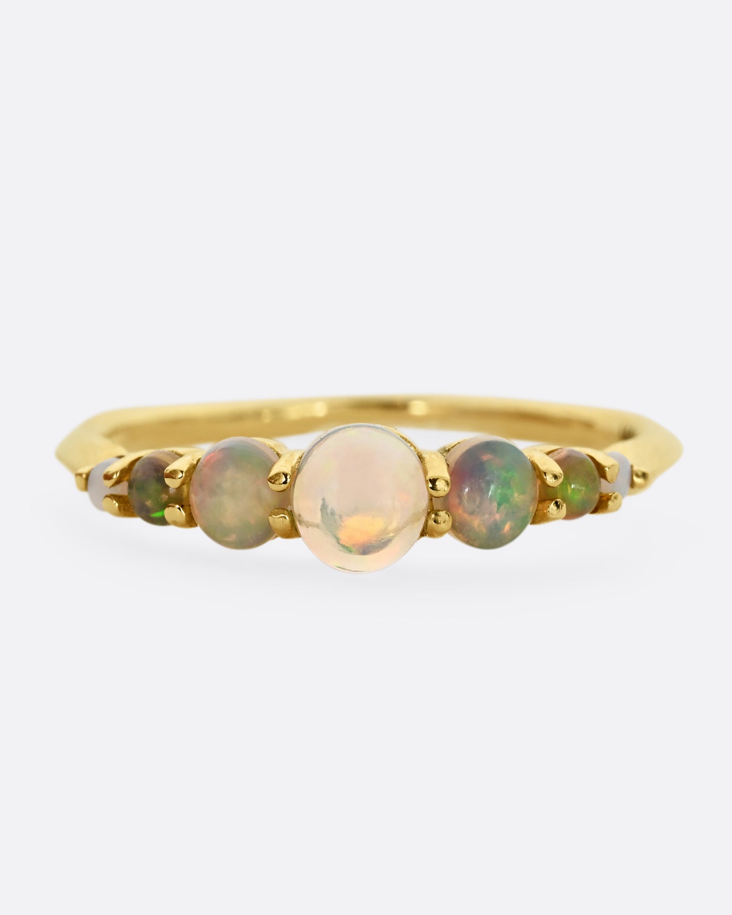 Seven graduated opals set in 18k yellow gold band. Shown from the front.