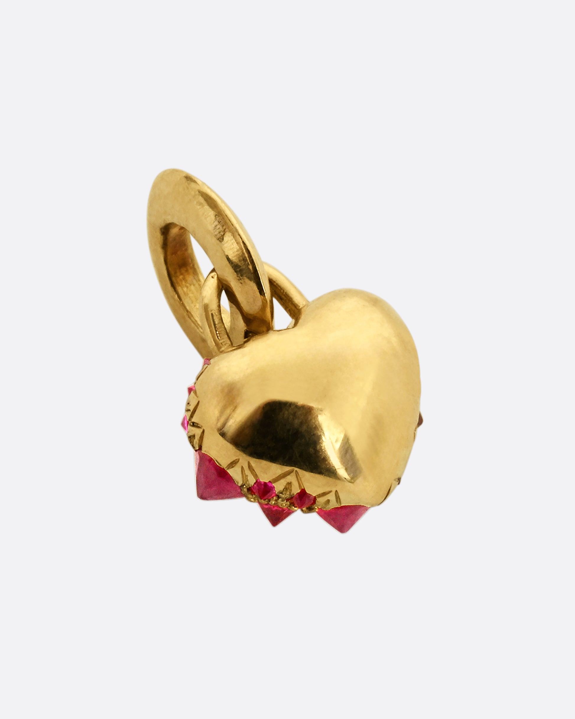 A yellow gold heart shaped charm with inverted rubies throughout. View from the back.