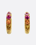 Gradient pink and orange inverted sapphires set in 18k yellow gold huggie hoops. Shown from the front.