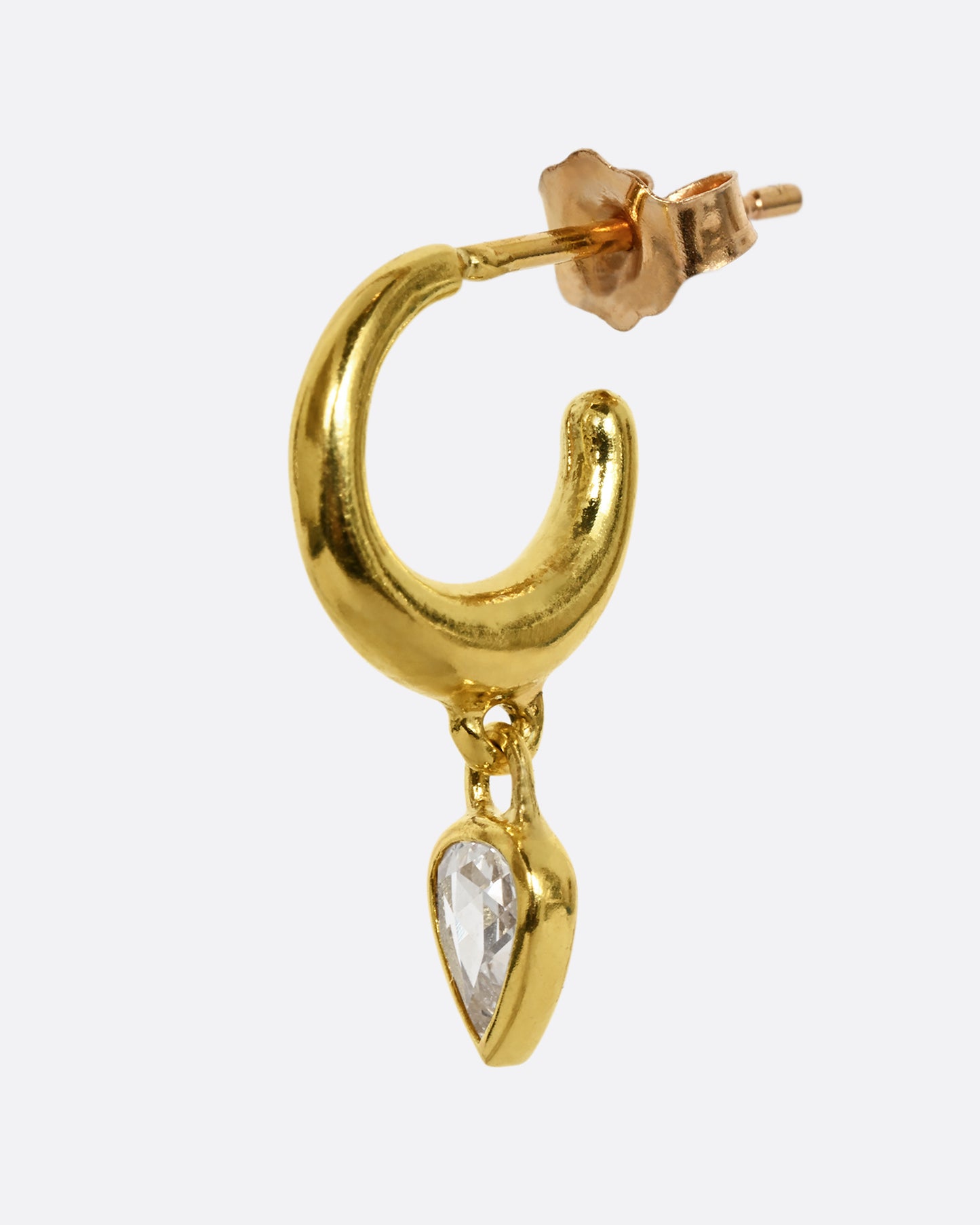 A yellow gold hoop earring with a diamond dangle, shown from the side.