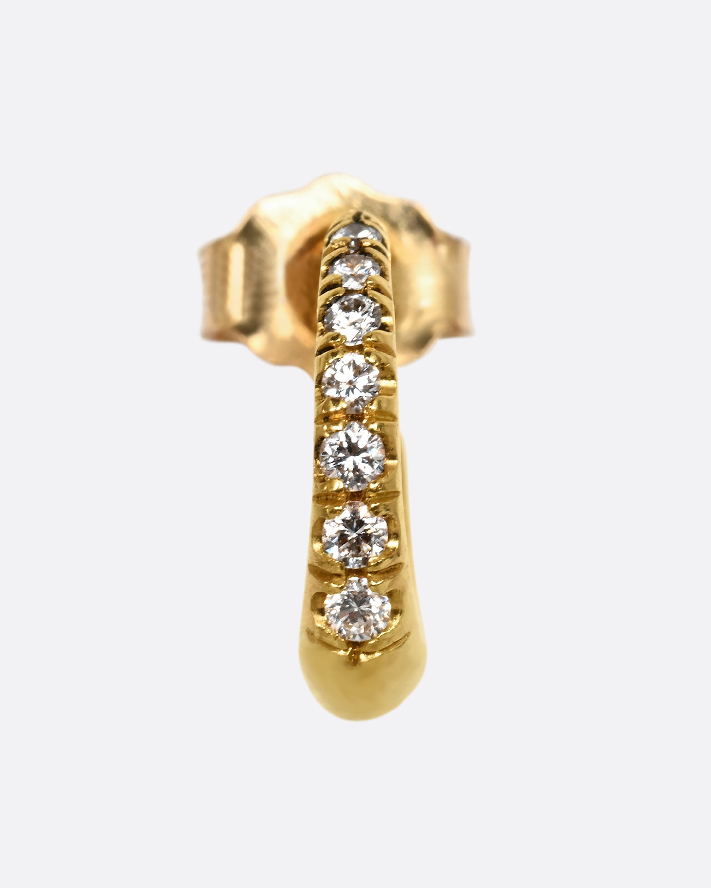 A yellow gold earring with graduated diamonds. Shown from the front.