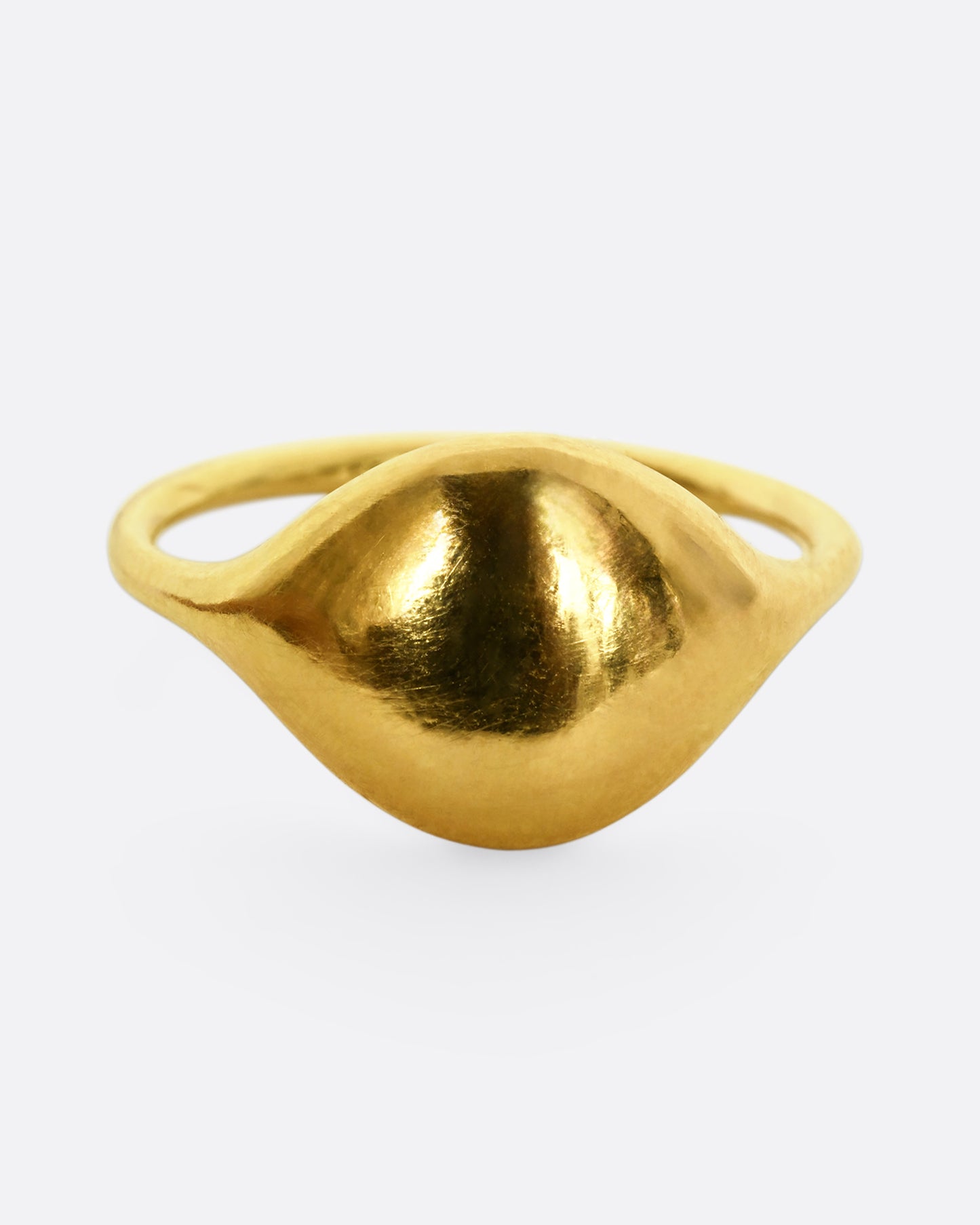 A yellow gold rounded signet ring. Shown from the front.