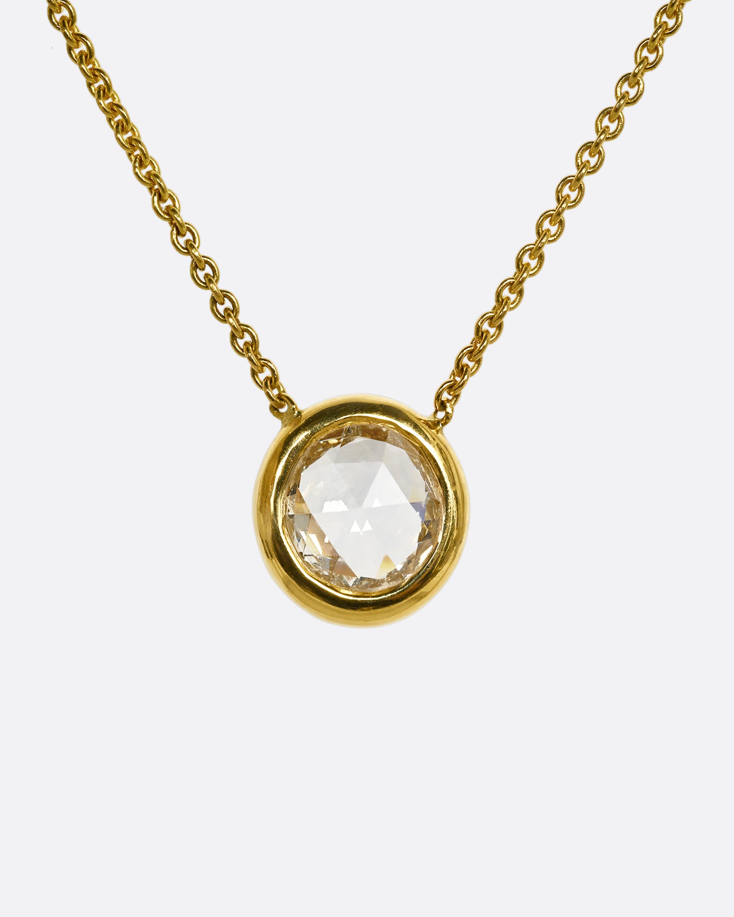 A yellow gold necklace with a circular shaped rose cut diamond. Shown from the front.