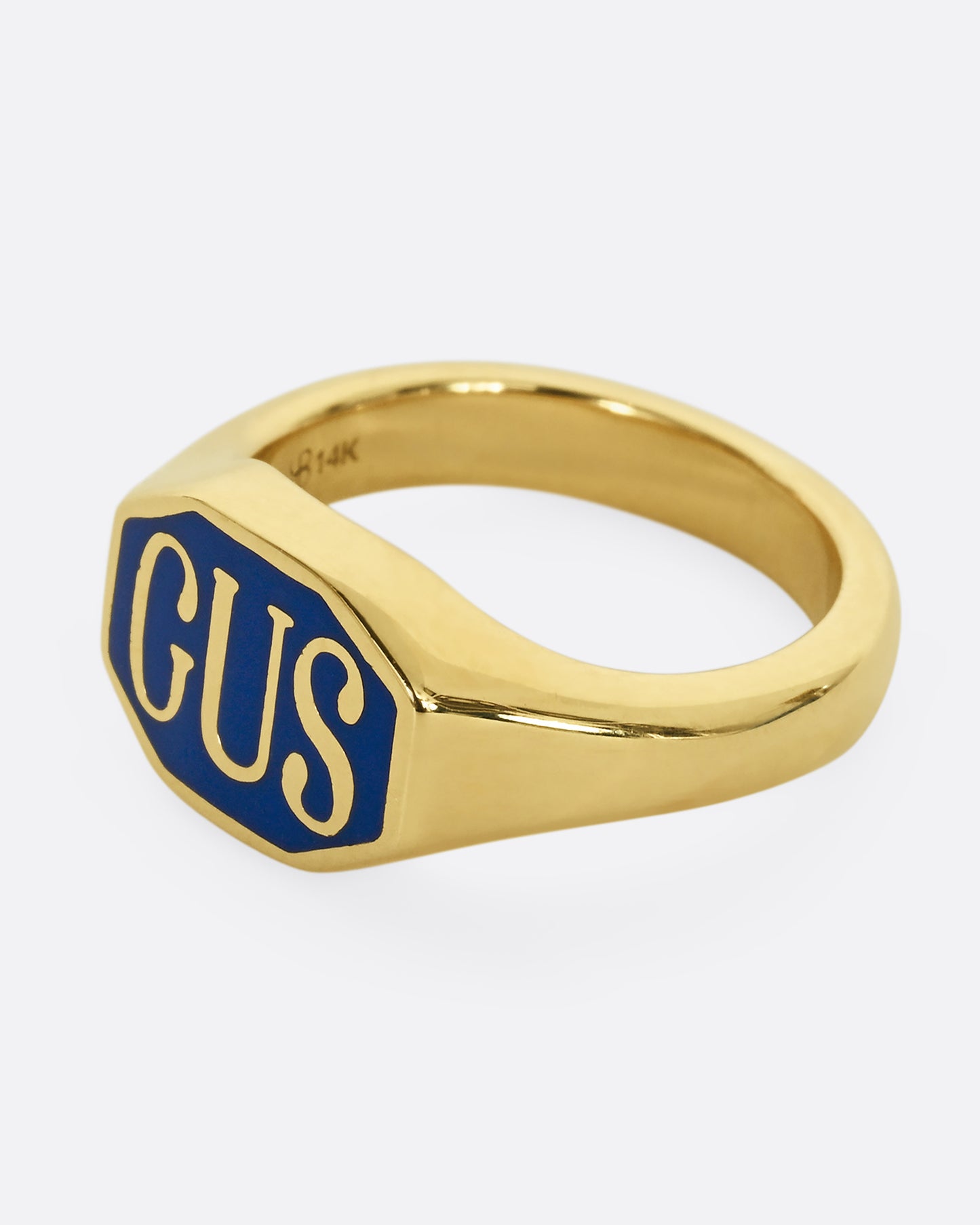 A yellow gold signet ring with the initials "GUS" and blue enamel. Shown from the side.