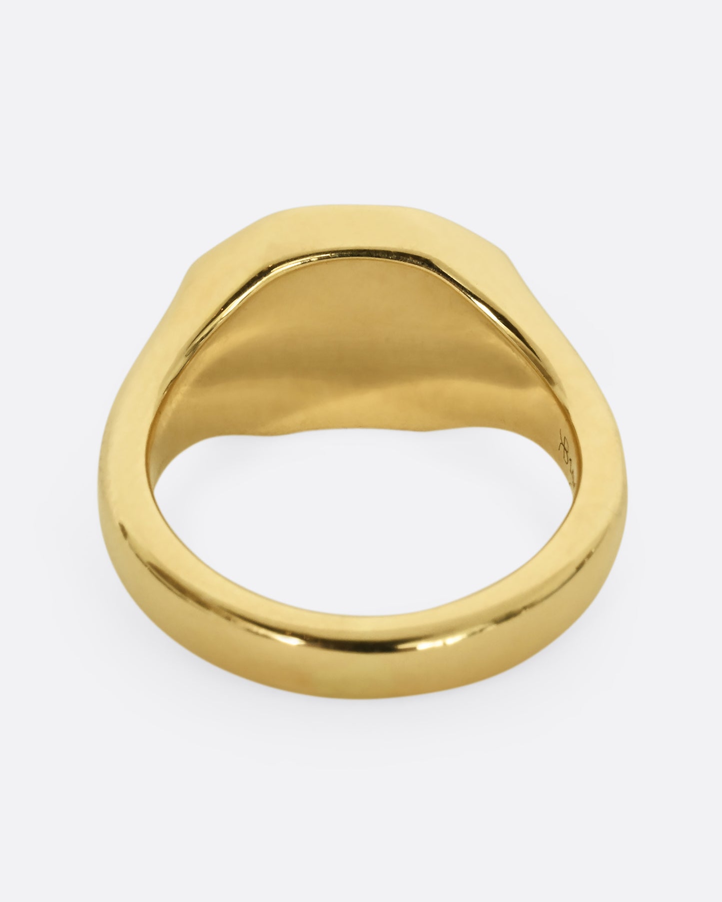 A yellow gold signet ring with the initials "GUS" and blue enamel. Shown from the back.