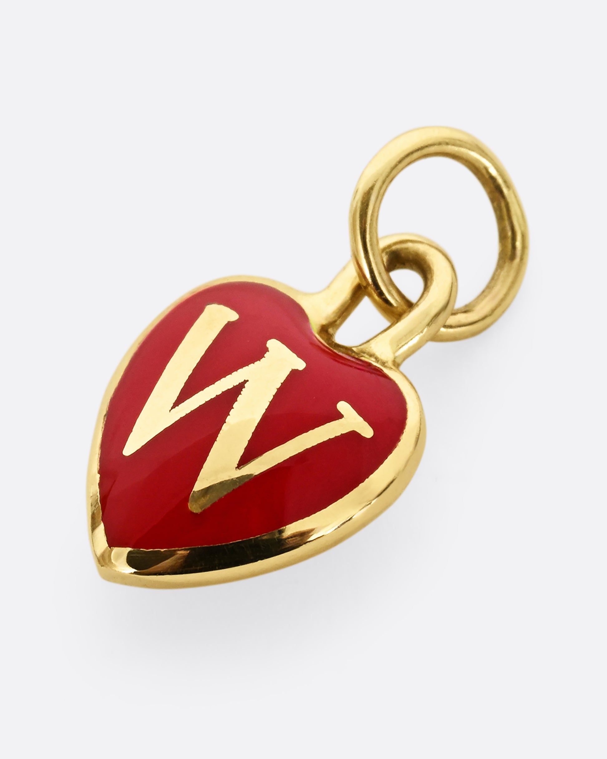 A yellow gold letter "W" heart shaped charm with red enamel. Shown from the front, laying flat.