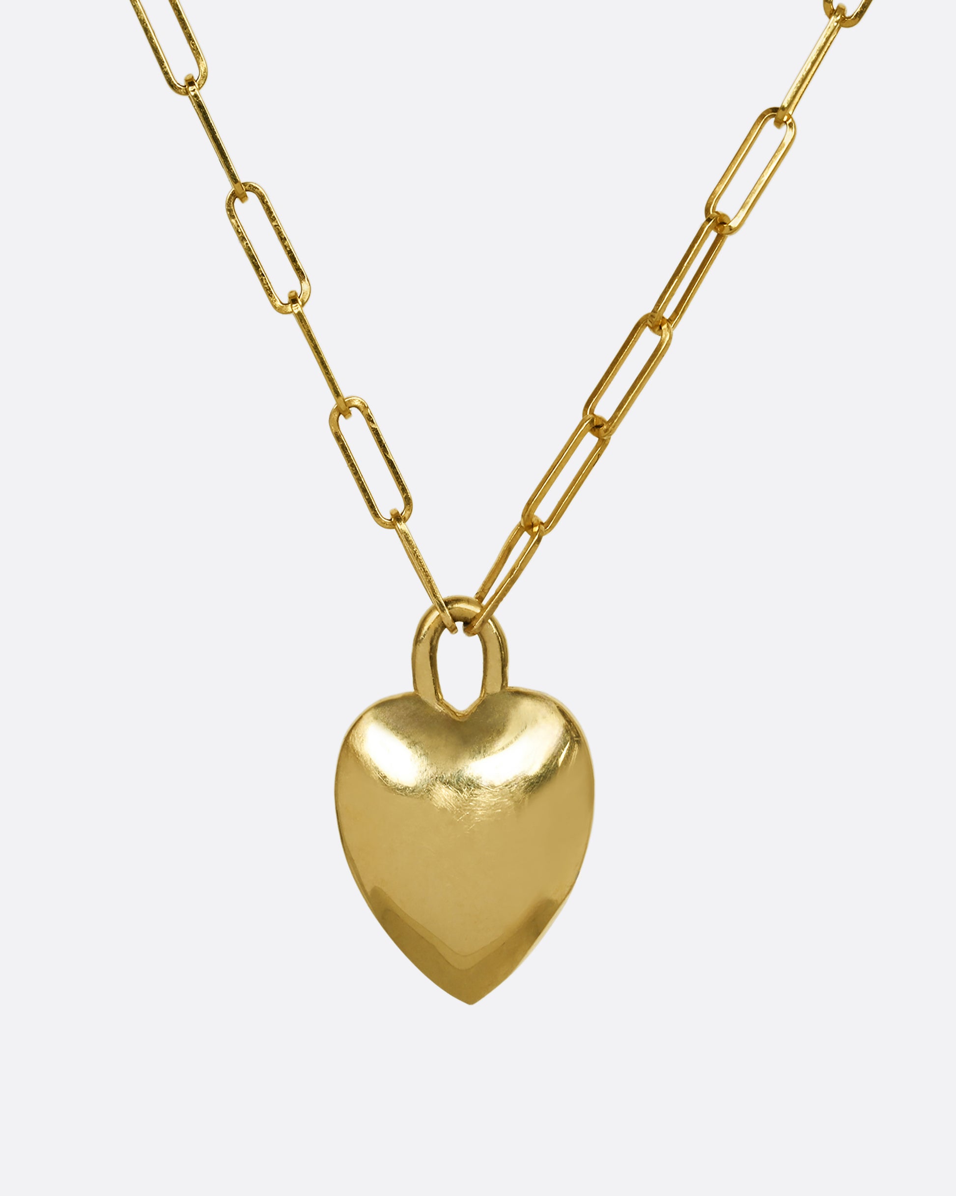 A yellow gold paper clip chain necklace with a heart shaped pendant that has green enamel and the letter "A". Shown from the back.