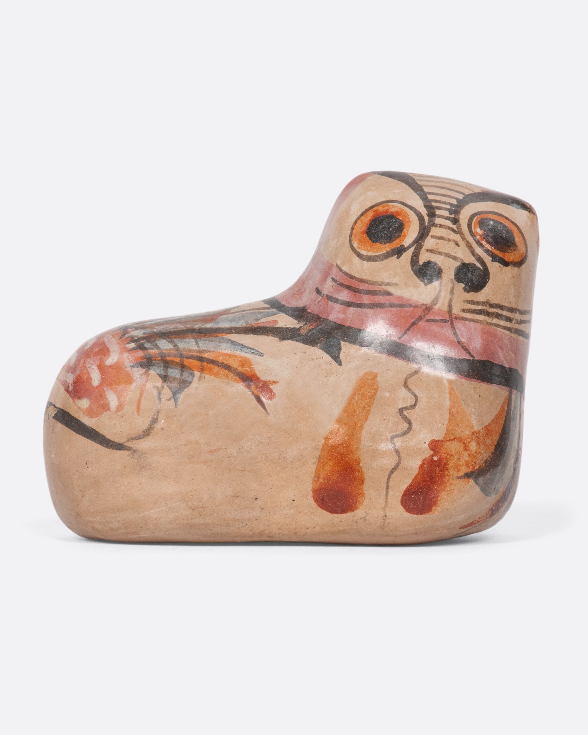 A vintage ceramic rounded cat figurine with hand painted features.