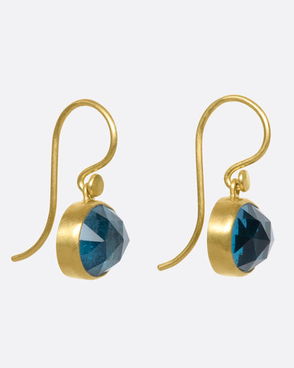 Yellow gold London blue topaz drop earrings, side view showing the hook wires and bezels