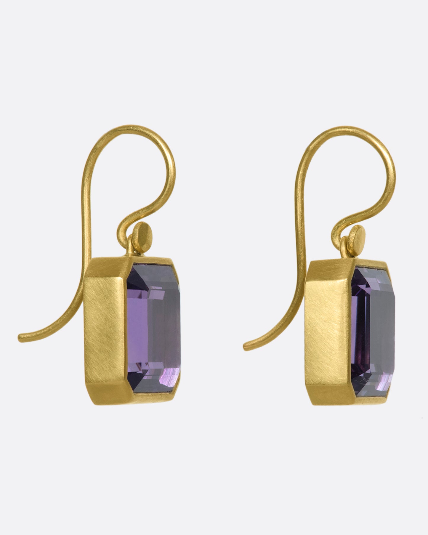 A pair of 18k gold drops with amethyst cubes. The octagonal shape adds extra dimension to the deep purple stone, making it change colors when viewed from different angles.