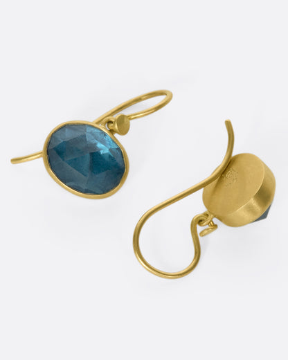 Yellow gold London blue topaz drop earrings, the pair laid flat, one from the front and one from the back