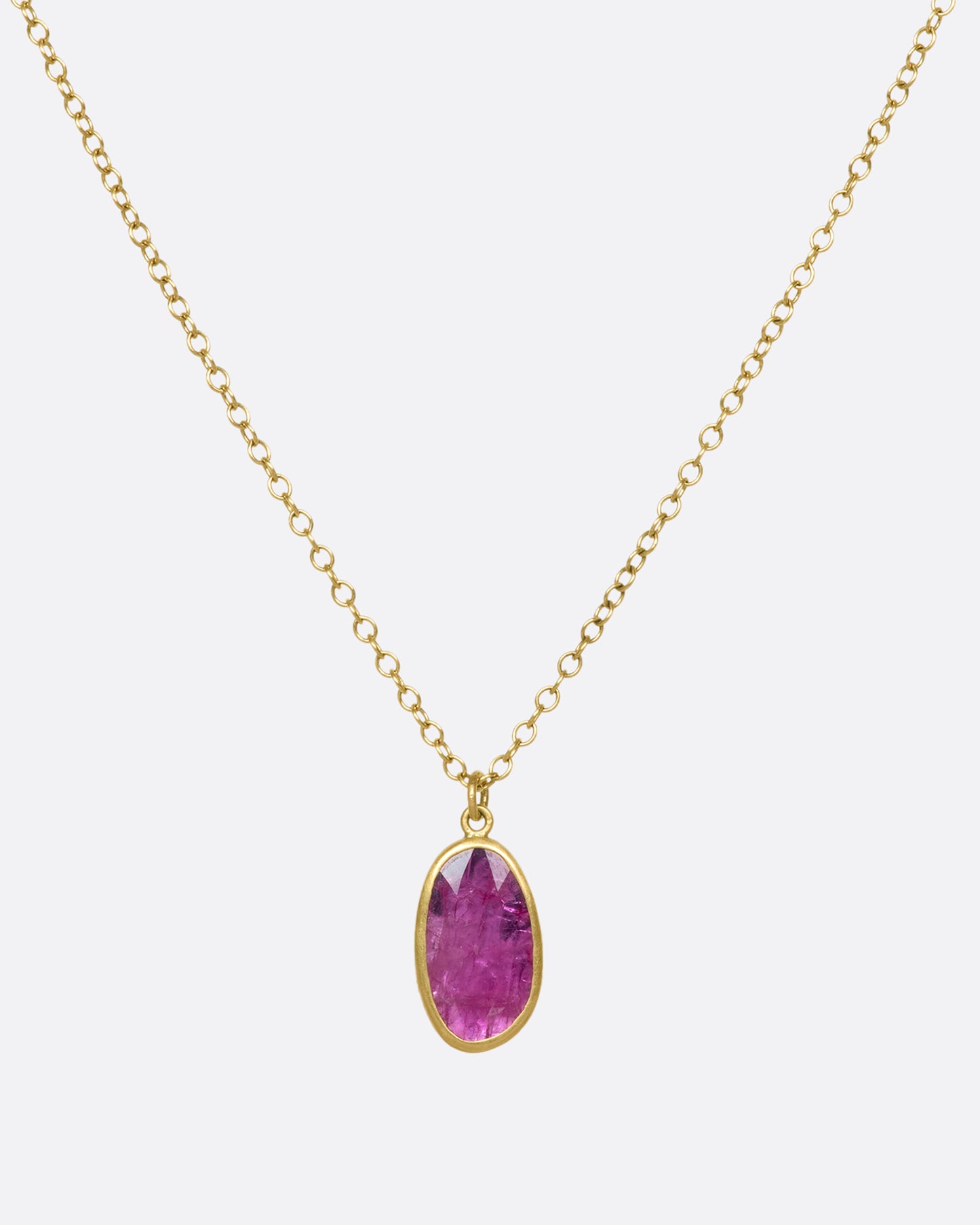 An 18k gold chain with an oval ruby pendant. Rubies are revered for their strong connection to solar energy—symbols of vitality, creativity, and confidence.