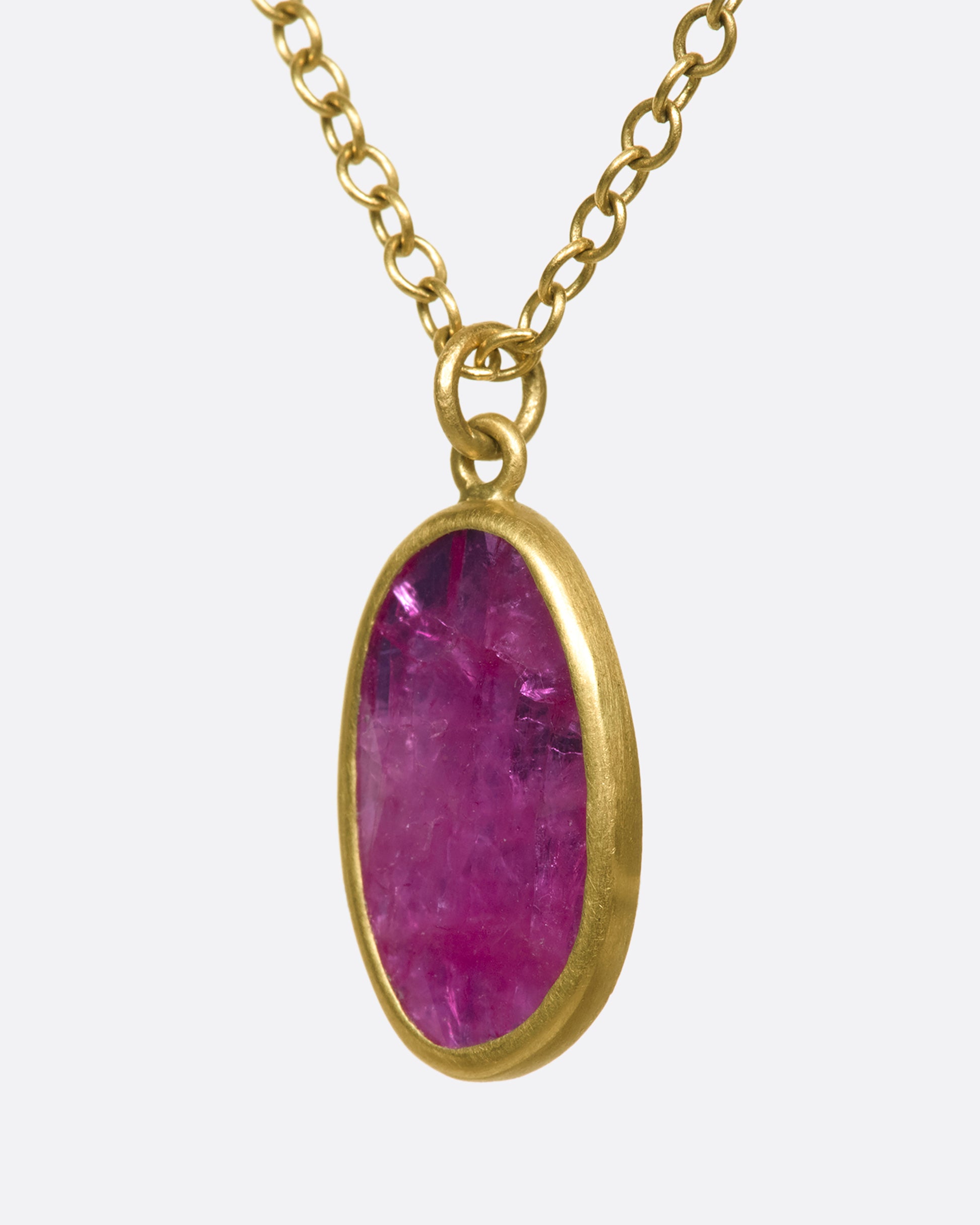 An 18k gold chain with an oval ruby pendant. Rubies are revered for their strong connection to solar energy—symbols of vitality, creativity, and confidence.