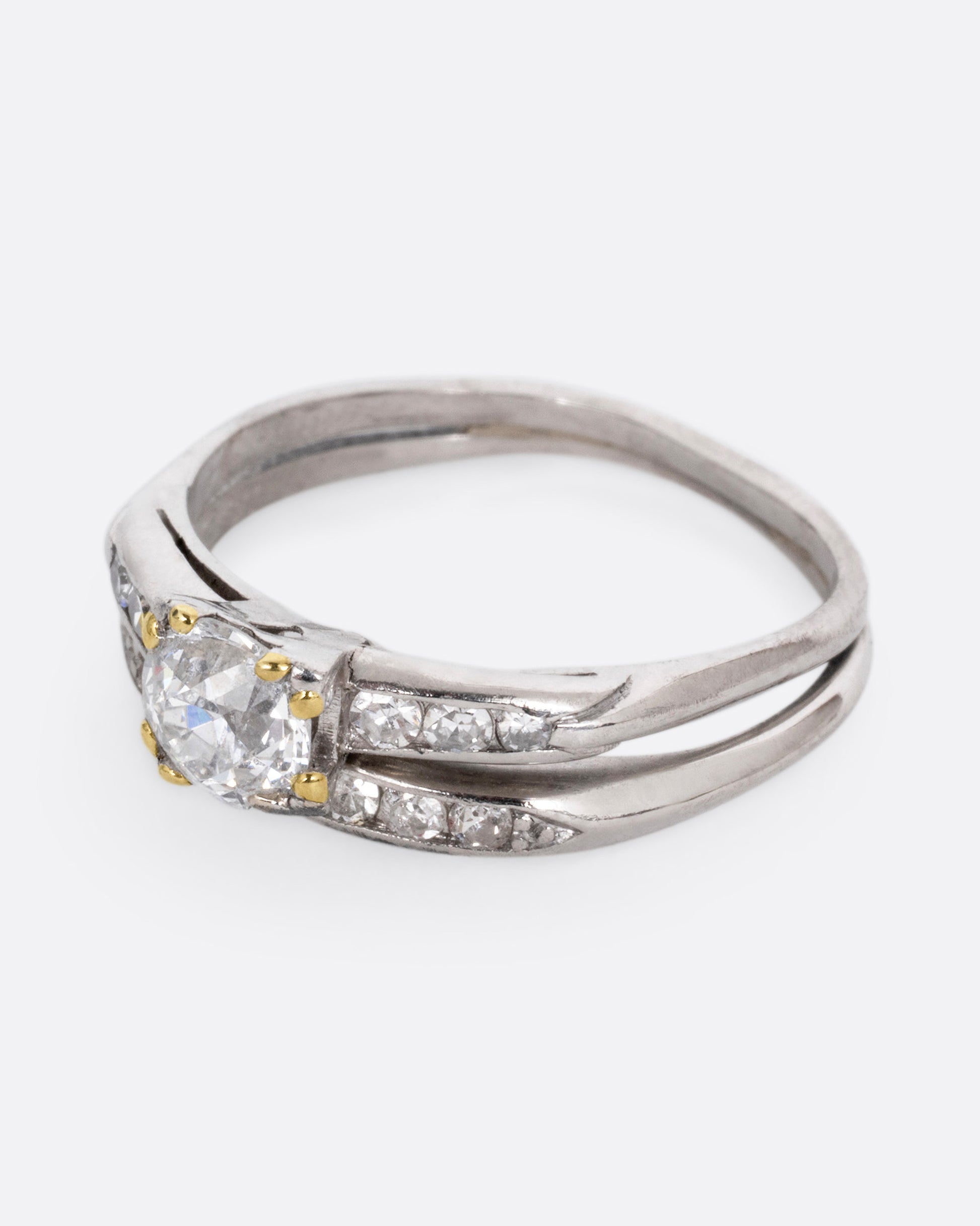 A platinum ring with an Old European cut diamond and a split shank, shown from the side.