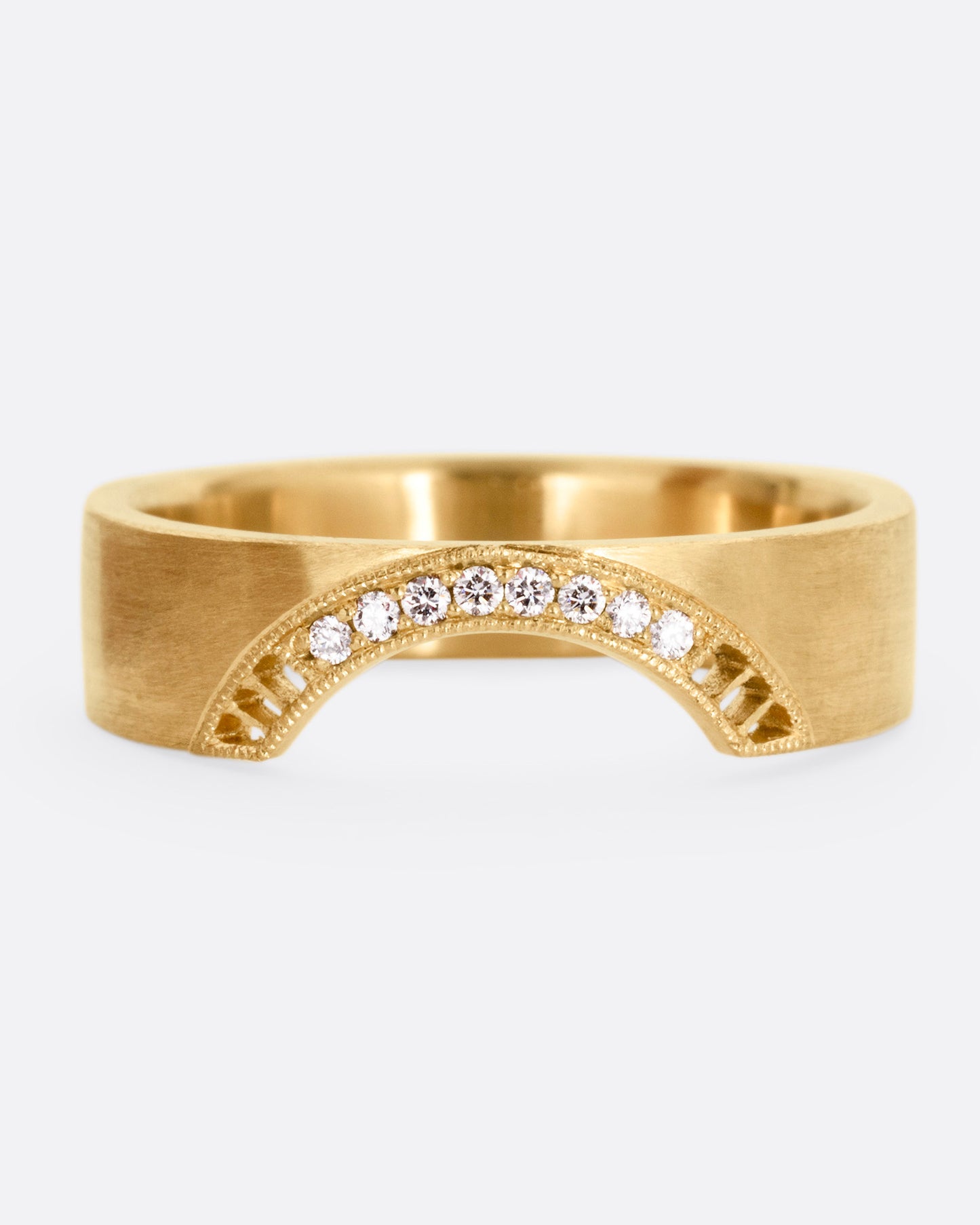 A yellow gold arched ring with eight bead set diamonds set above the half moon cutout at the center, shown from the front.
