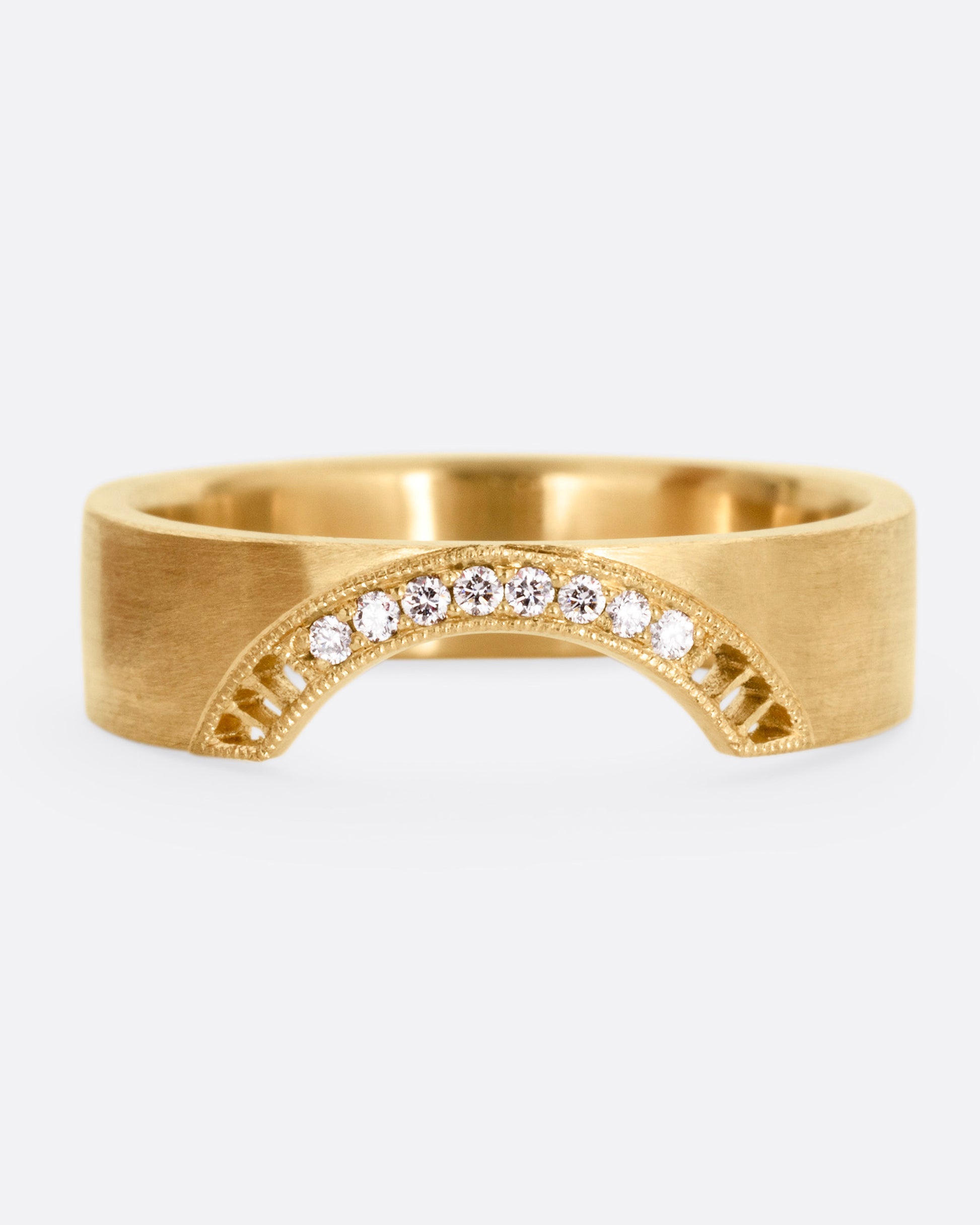 A yellow gold arched ring with eight bead set diamonds set above the half moon cutout at the center, shown from the front.