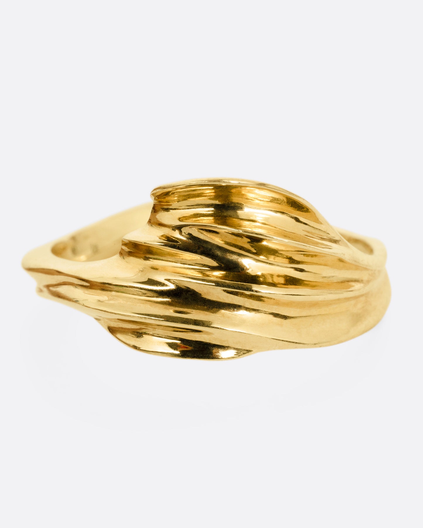 A yellow gold ring with a fluid, dimensional silhouette and narrow back, shown from the front.