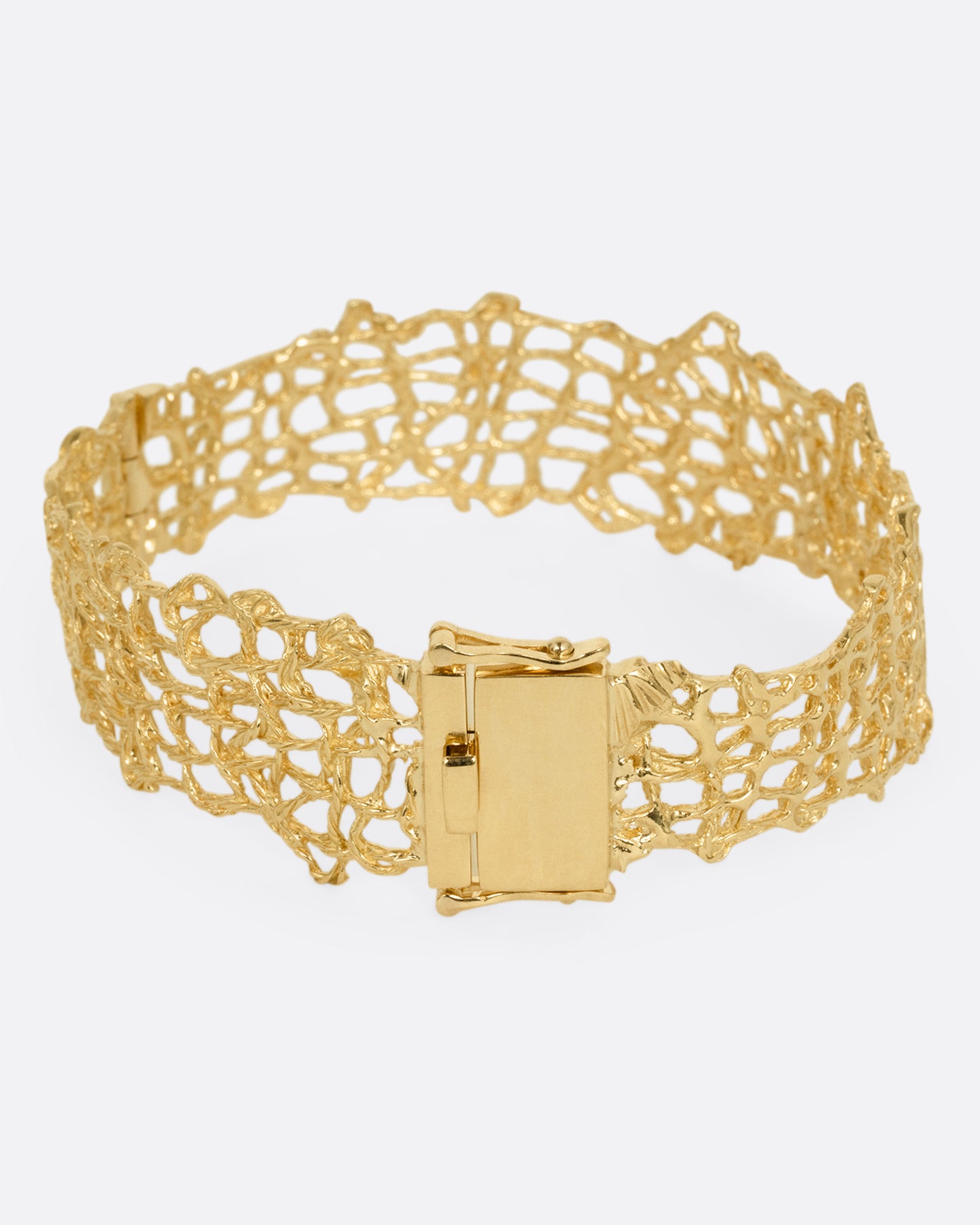 A woven yellow gold wire strand bracelet shown from the back.