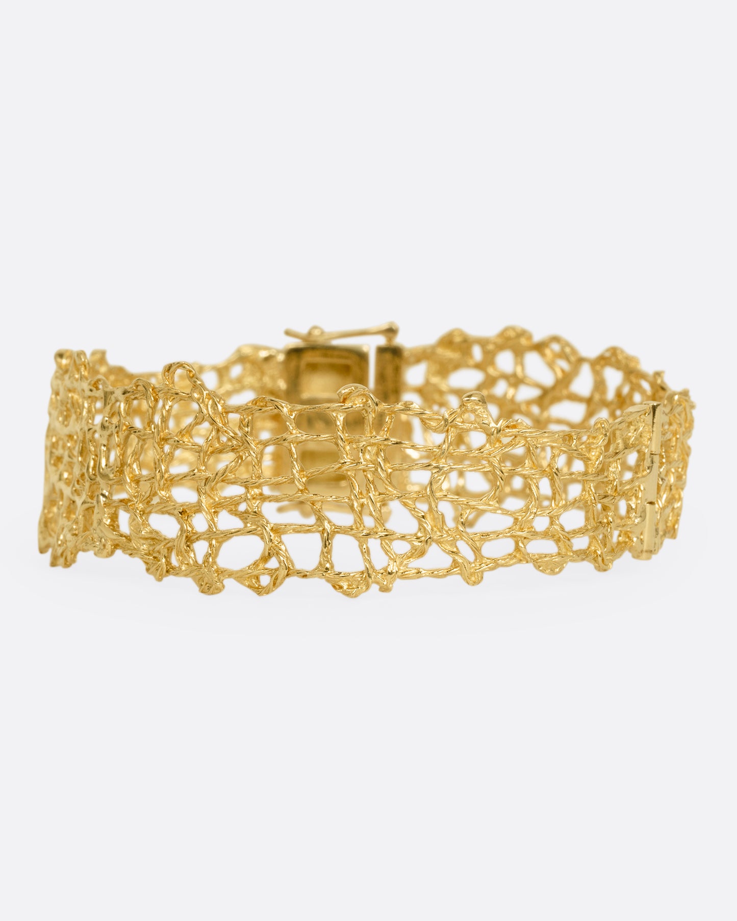 A woven yellow gold wire strand bracelet shown from the front.