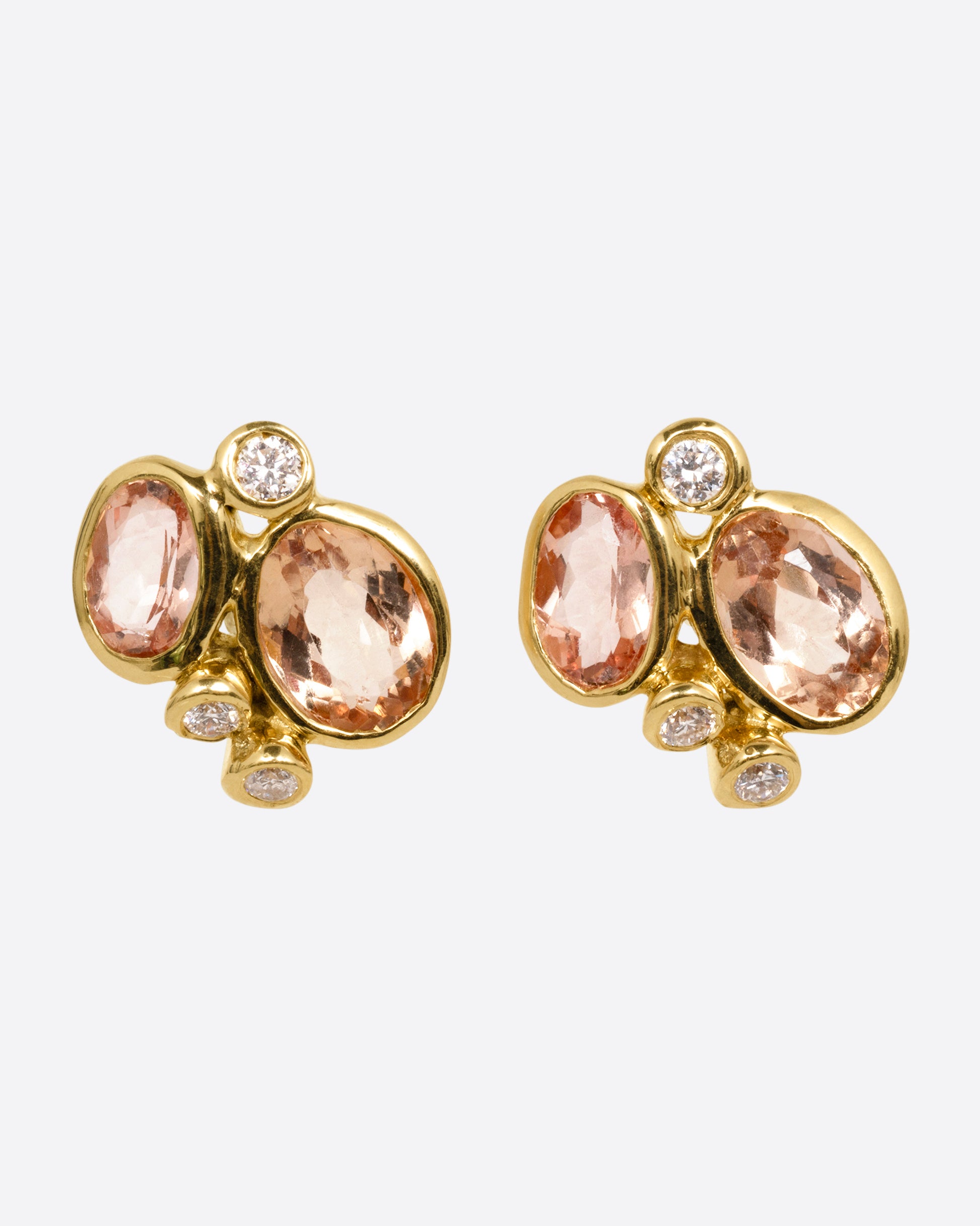 A pair of yellow gold stud earrings with clusters of pink tourmalines and white diamonds, shown from the front.