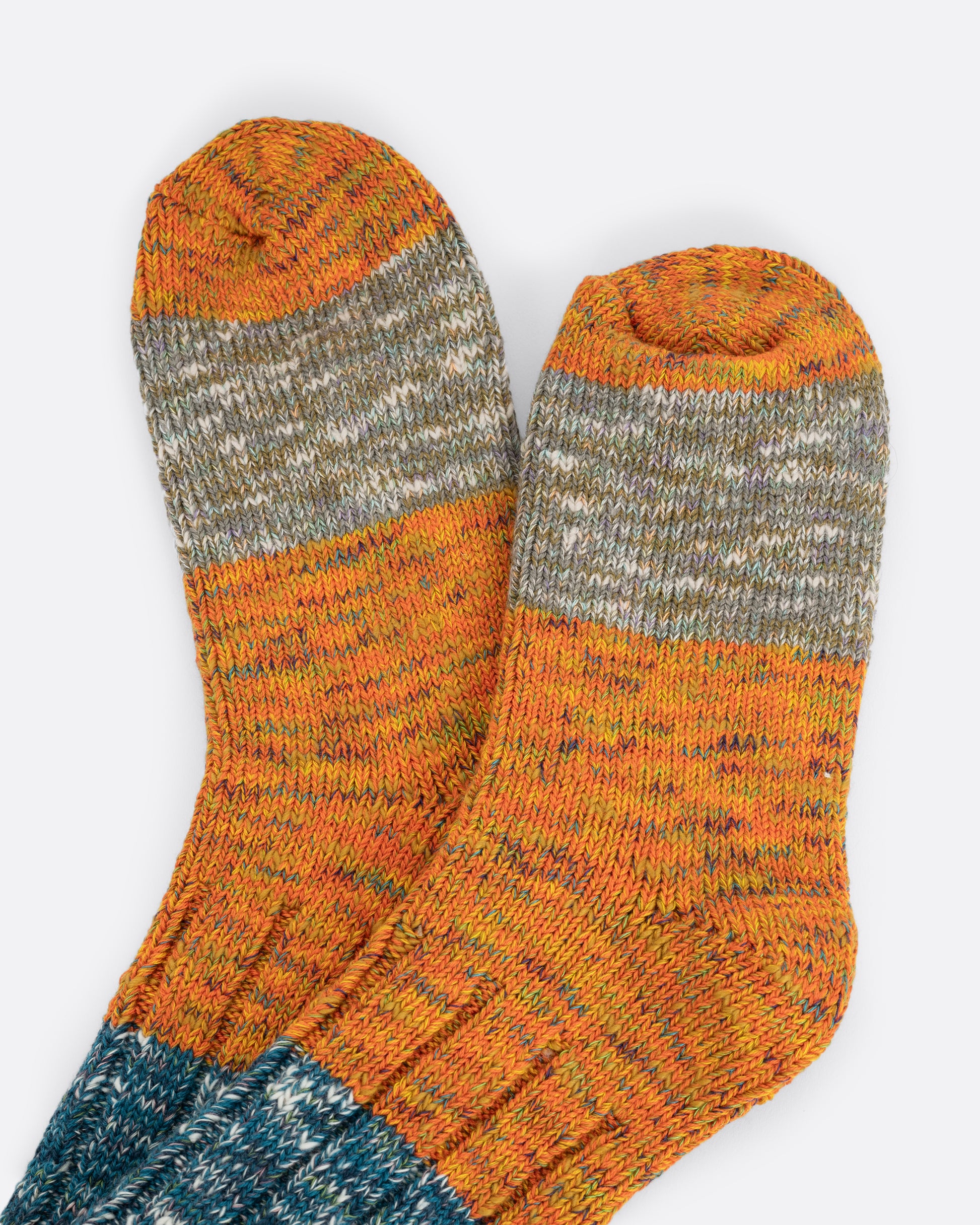 Orange and blue melange ribbed socks. View close up.