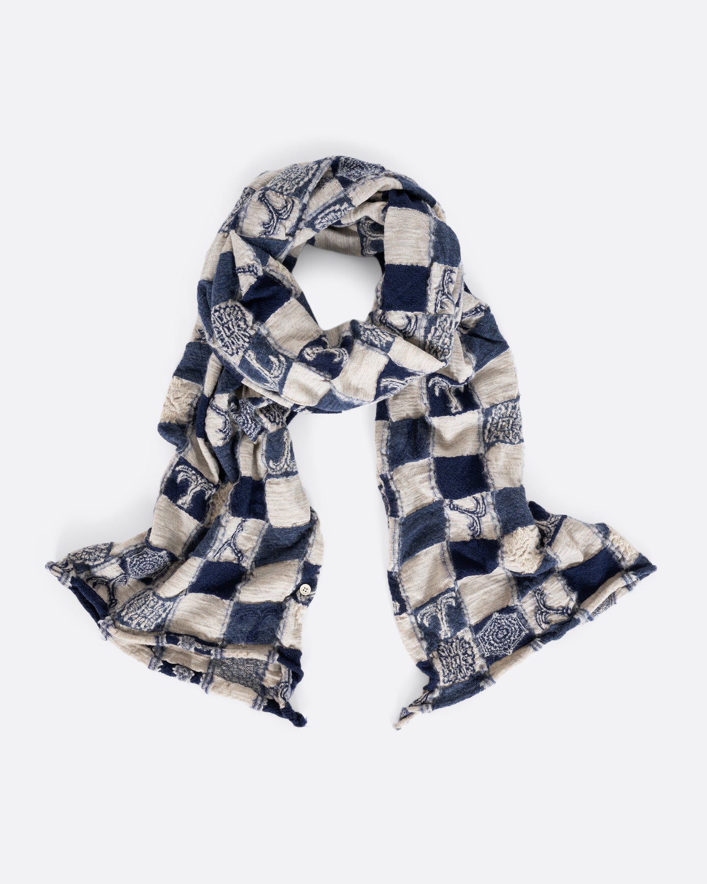 A grey and navy blue checkered scarf with a nautical print. Shown loosely tied. 