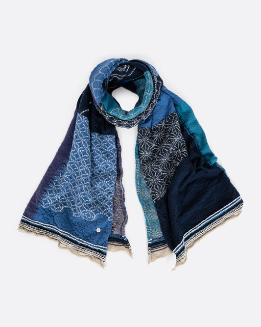 A blue patchwork scarf. Shown loosely tied.