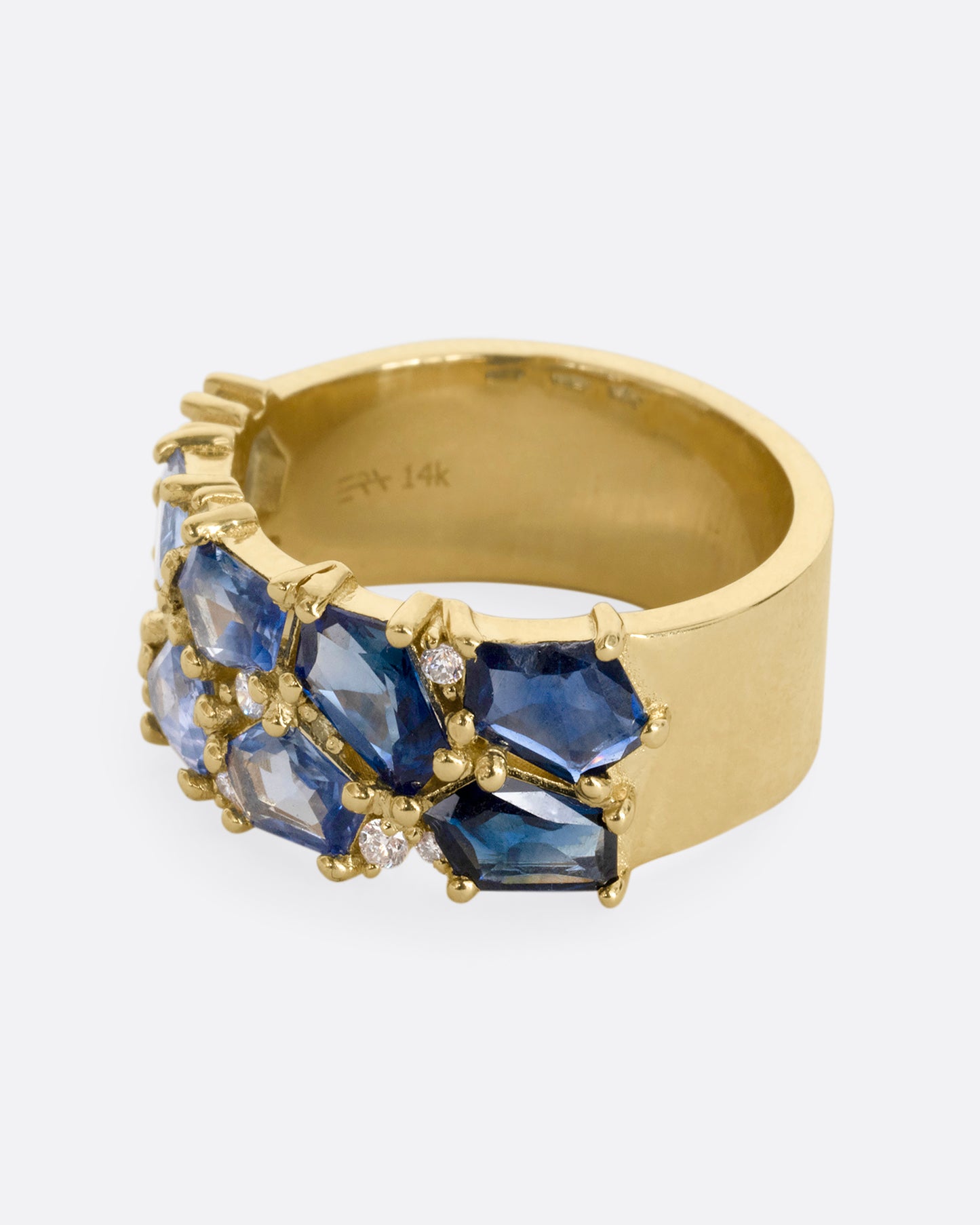 A yellow gold band with mosaic ombre blue sapphires and diamonds. Shown from the alternate side.