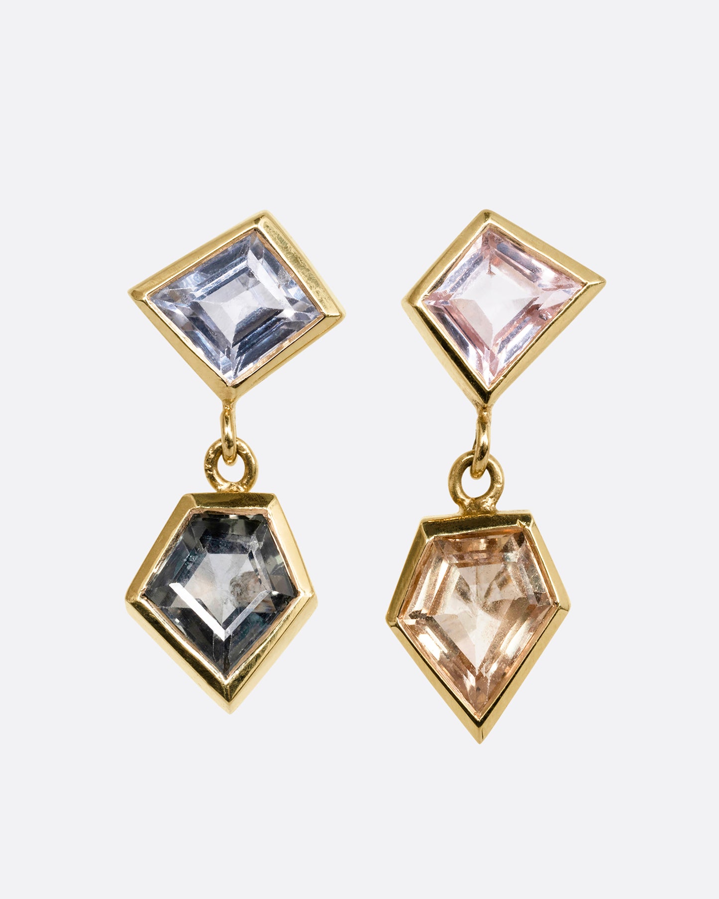 A pair of yellow gold drop earrings with trapezoid multicolor sapphires. Shown from the front.