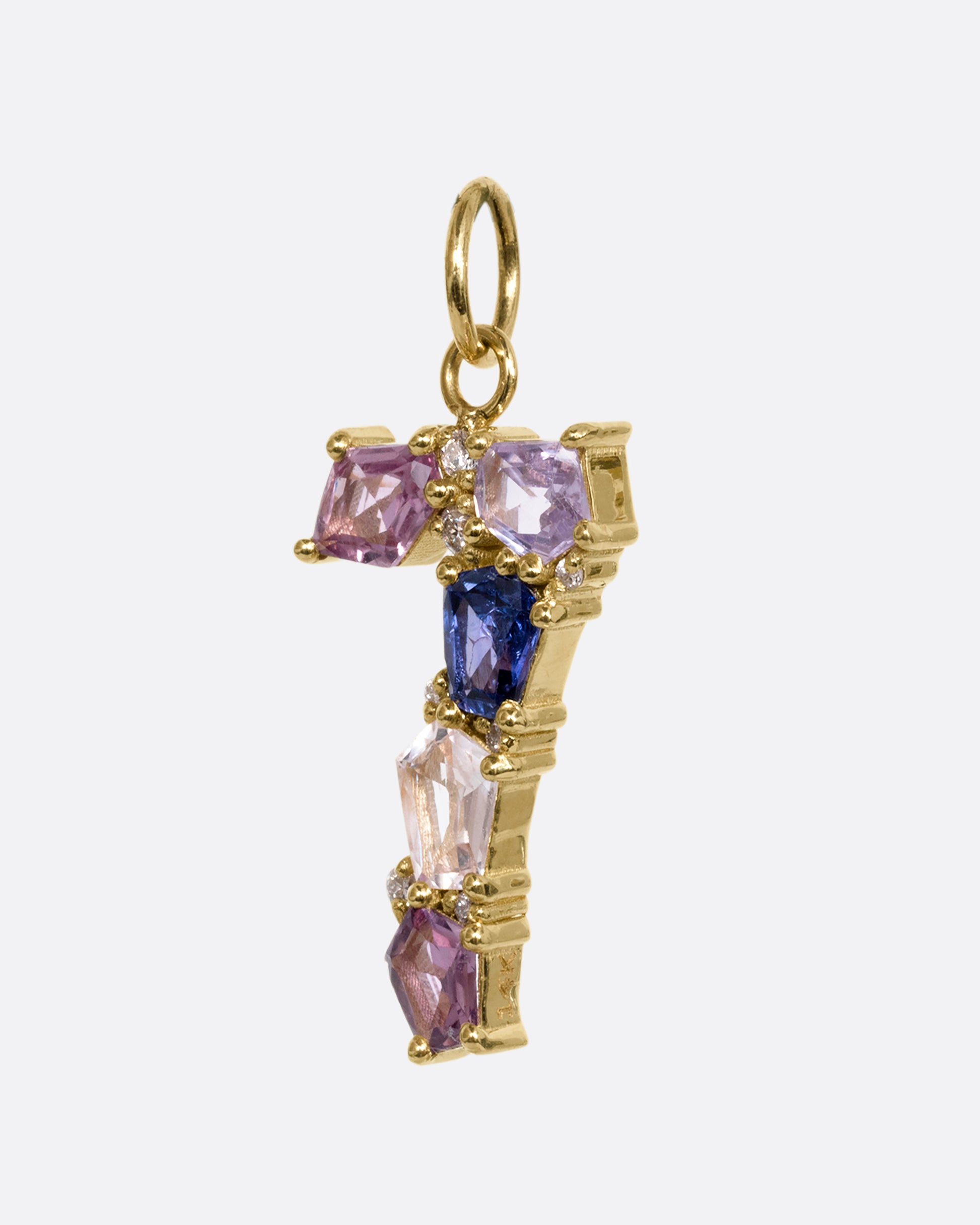 A yellow gold number "7" pendant made of mosaic multicolor sapphires and diamonds. Shown from the side.