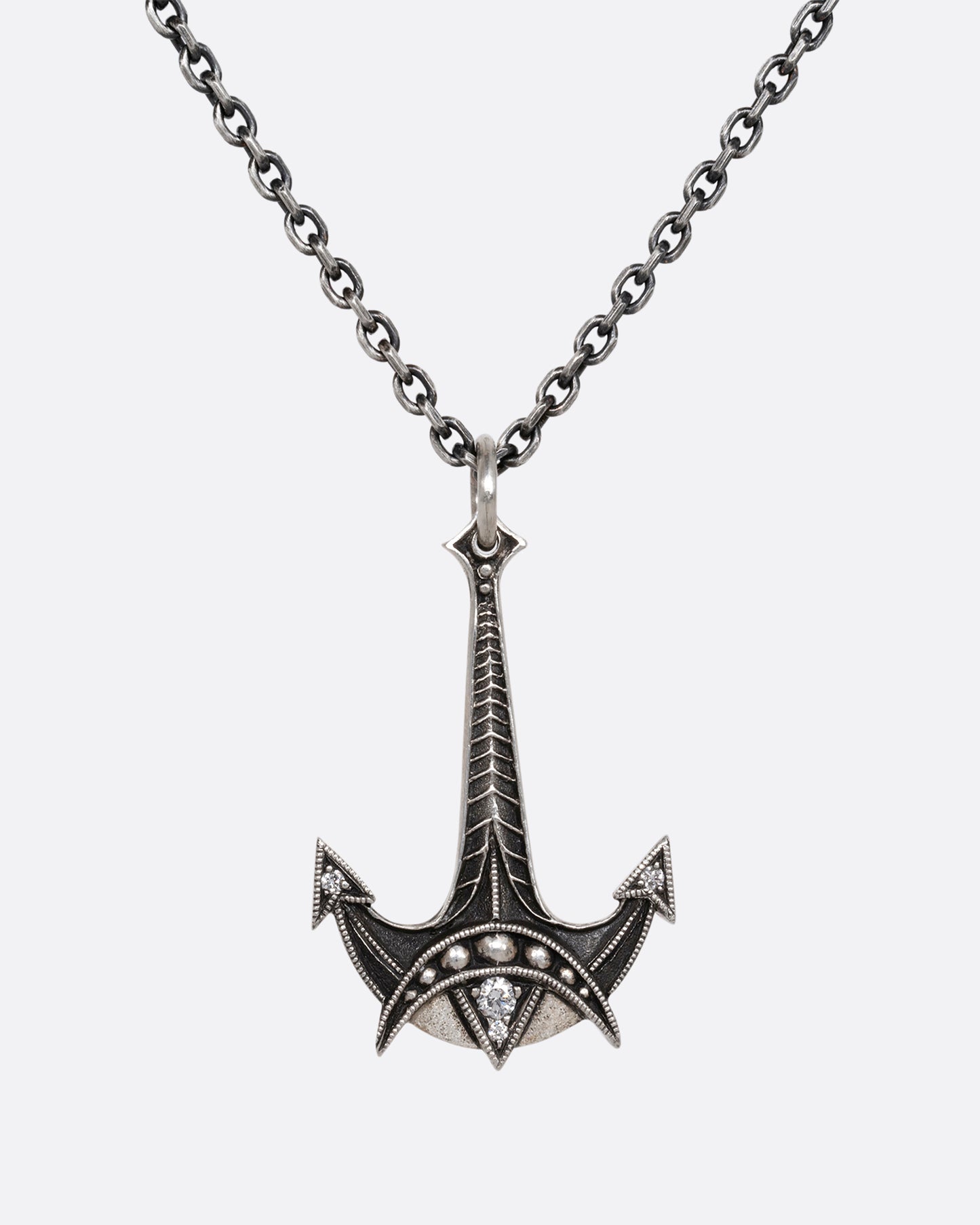 A sterling silver necklace with an anchor pendant and diamond details. Shown from the front.