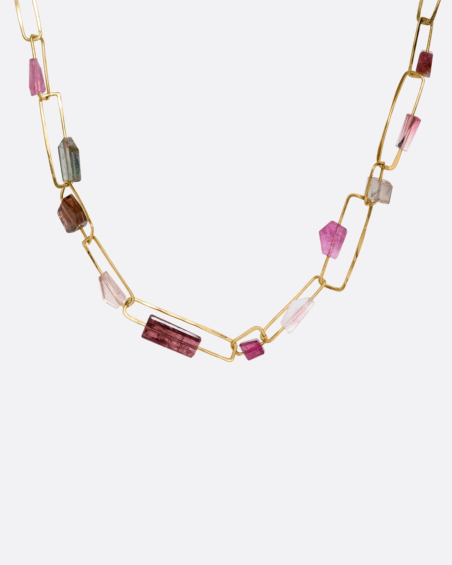 A yellow gold rectangular link necklace with multicolor and shape tourmalines. Shown from the front.