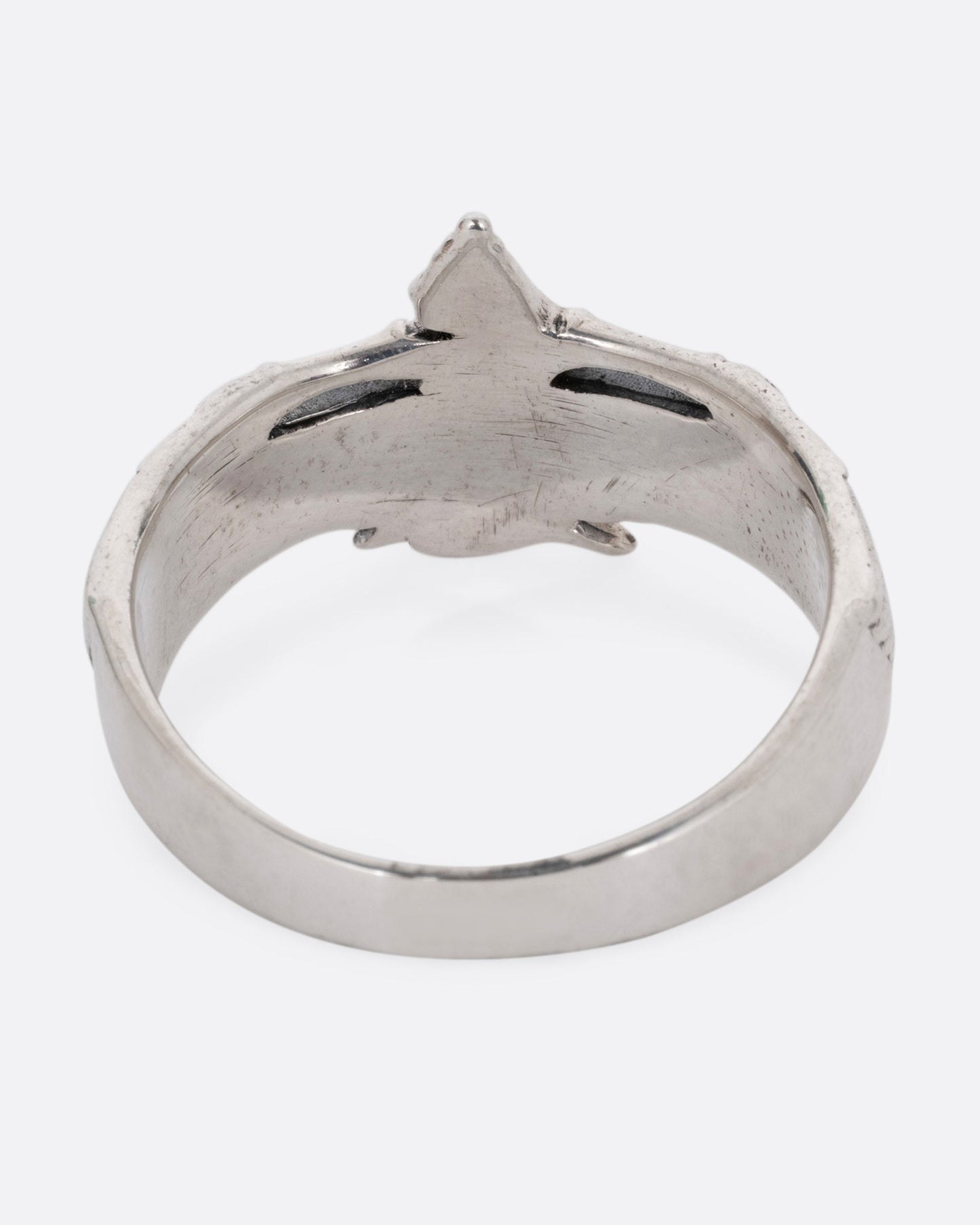 A silver ring with Isis, the ancient Egyptian goddess and powerful magician spreading her wings. Shown from the back.