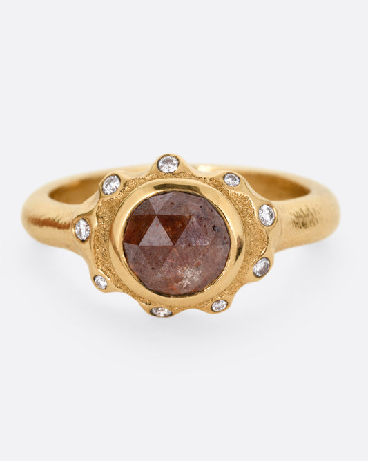 A yellow gold ring with a brown diamond and white diamond accents, shown from the front.