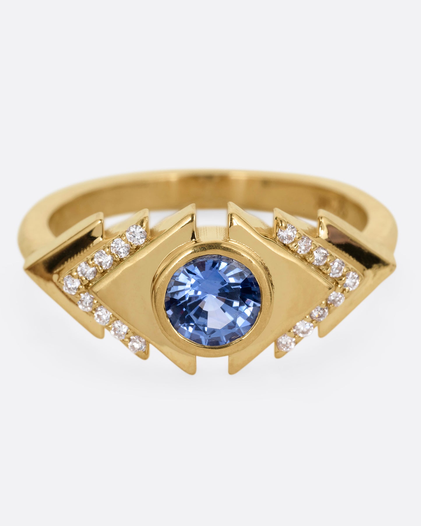 A yellow gold ring with a blue sapphire at the center of angular steps with diamond accents, shown from the front.
