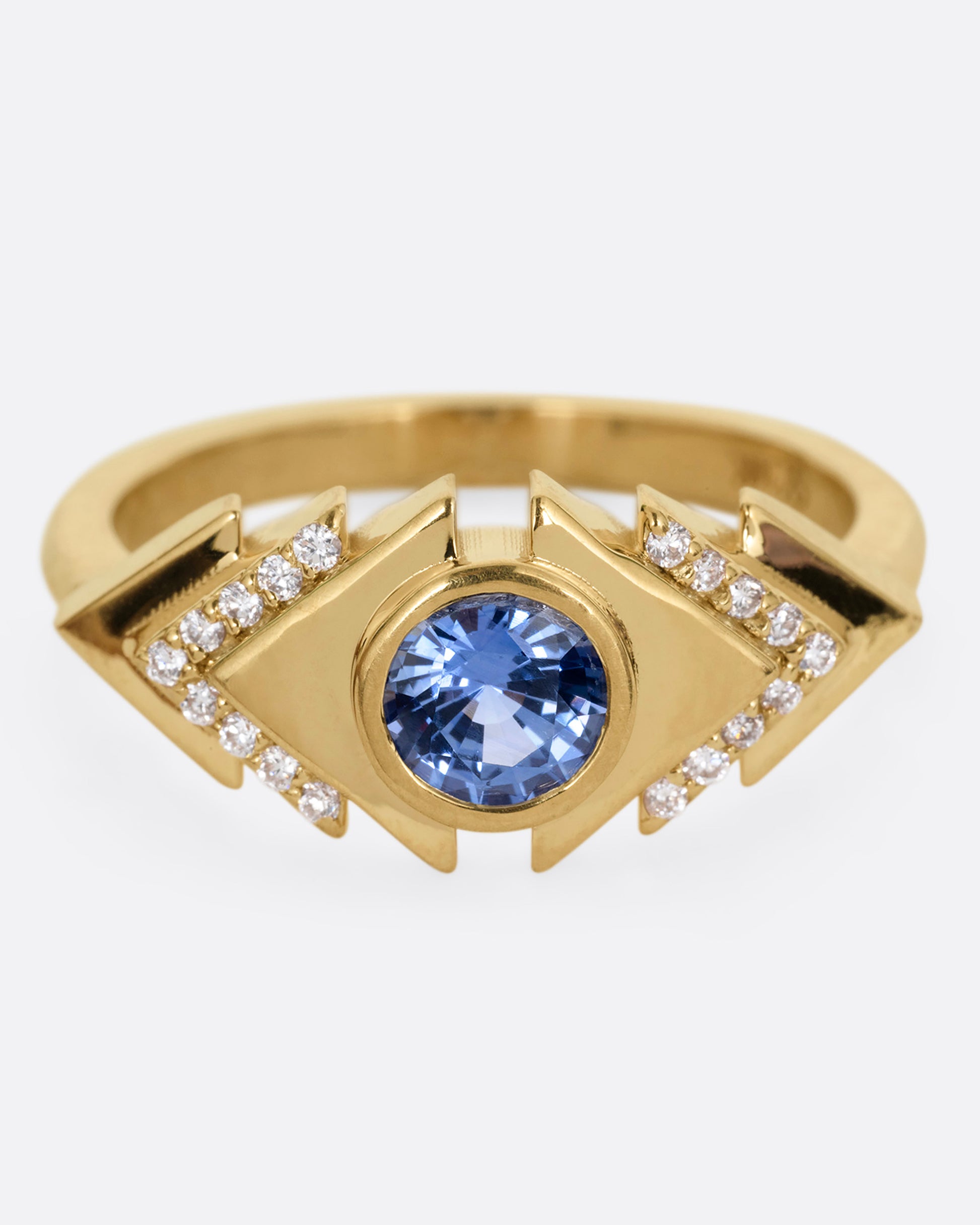 A yellow gold ring with a blue sapphire at the center of angular steps with diamond accents, shown from the front.