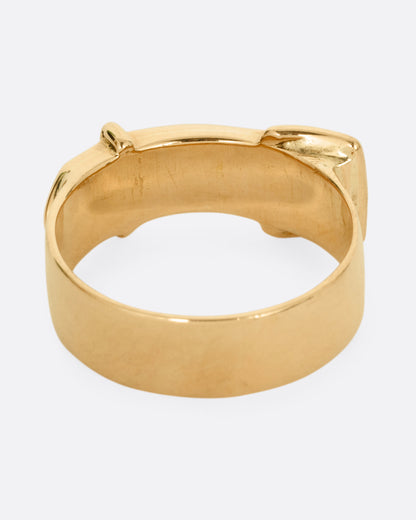A yellow gold Victorian remembrance buckle ring with an old mine cut diamond. Shown from the back.