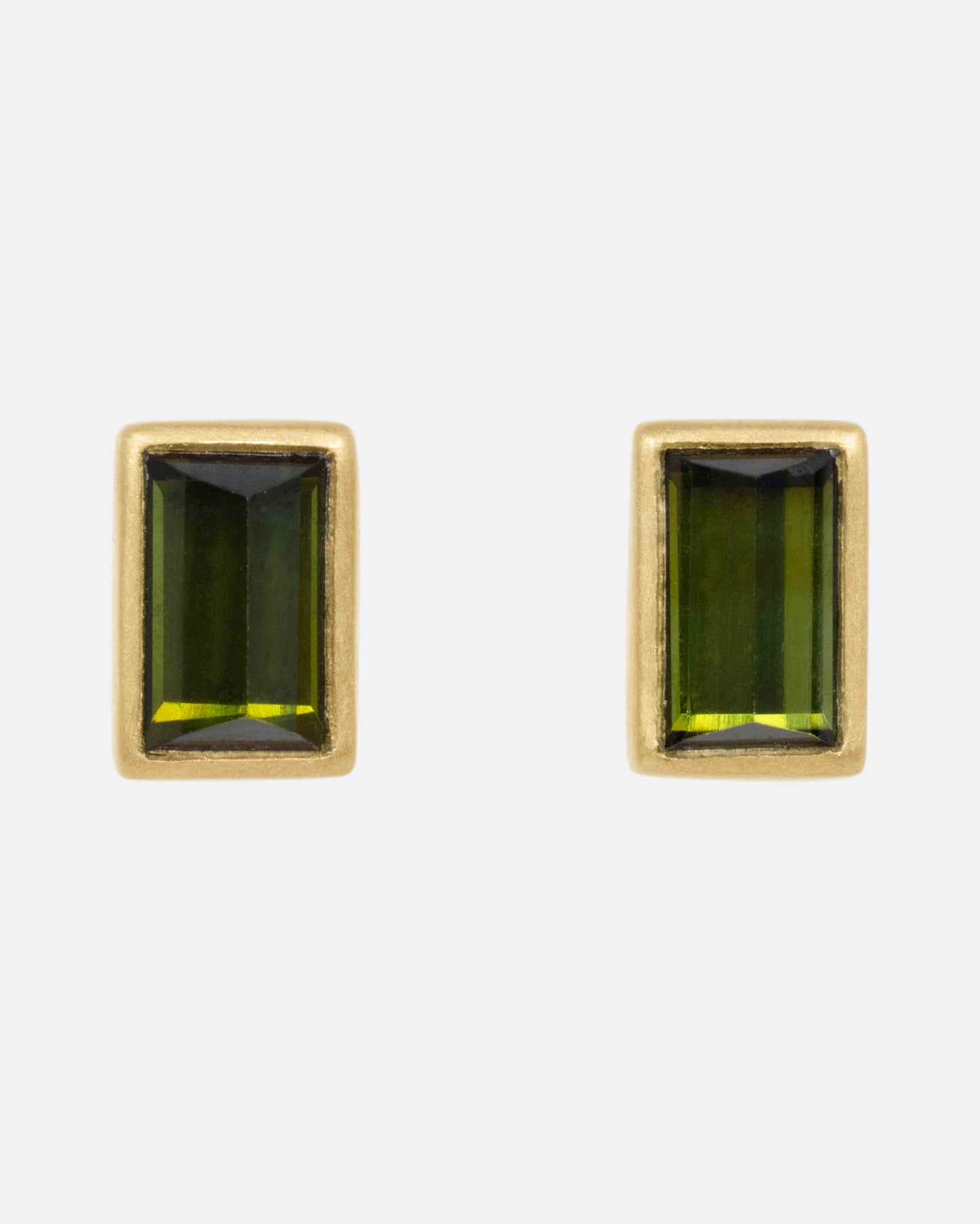 A pair of yellow gold green tourmaline baguette earrings, shown from the front.