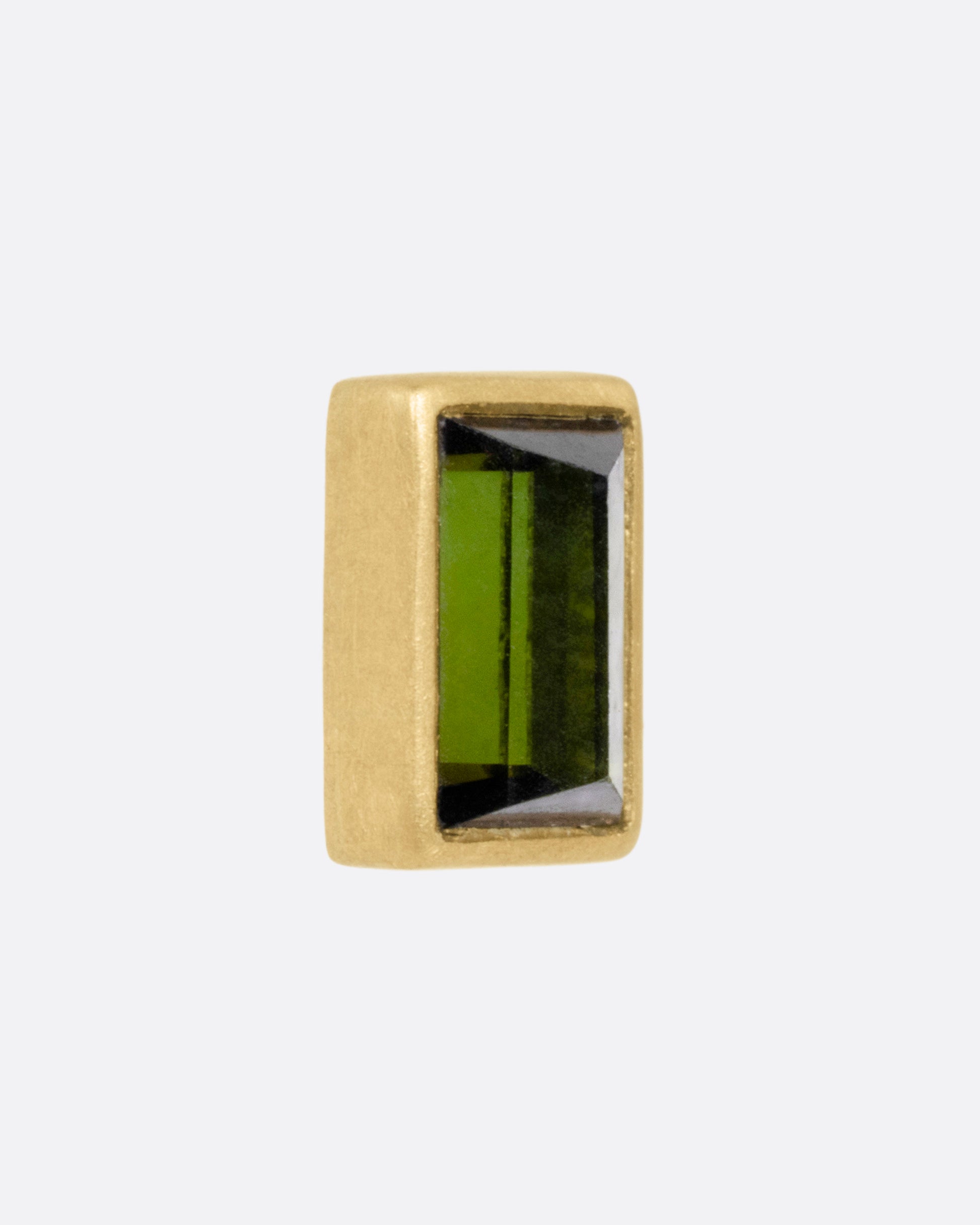 A yellow gold green tourmaline baguette earring, shown from the side.