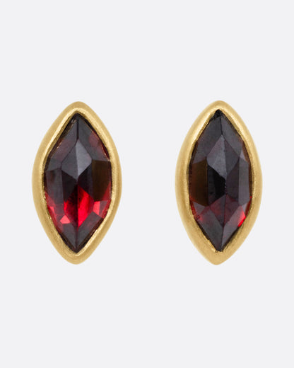 Yellow gold garnet navette stud earrings, the pair from the front