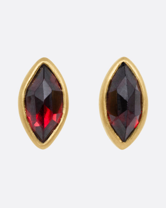 A pair of yellow gold navette garnet earrings, shown from the front.