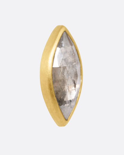 Yellow gold gray navette diamond stud earrings, close view of one stud showing the faceted diamond