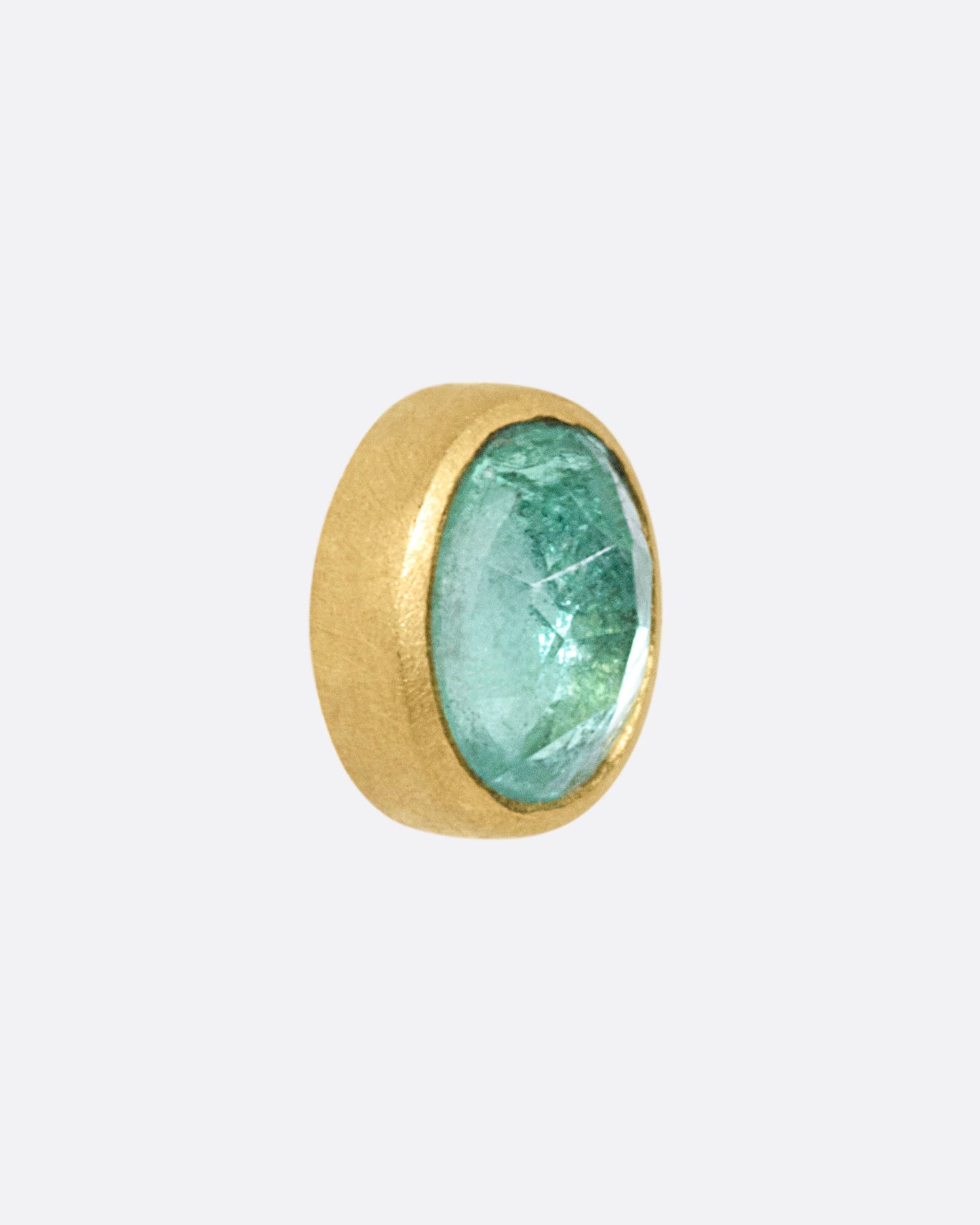 A yellow gold stud earring with a Colombian emerald, shown from the side.