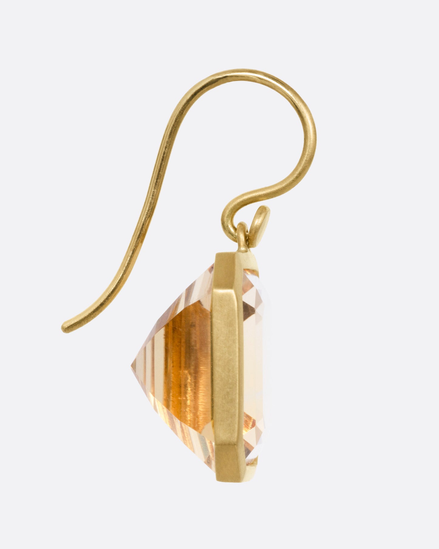 A yellow gold drop earring with an octagonal citrine, shown from the side.